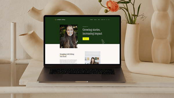 Laptop displaying a website with a green and white theme, featuring a portrait of a woman and text about editing services. The screen is set against a decorative backdrop with vases and flowers.