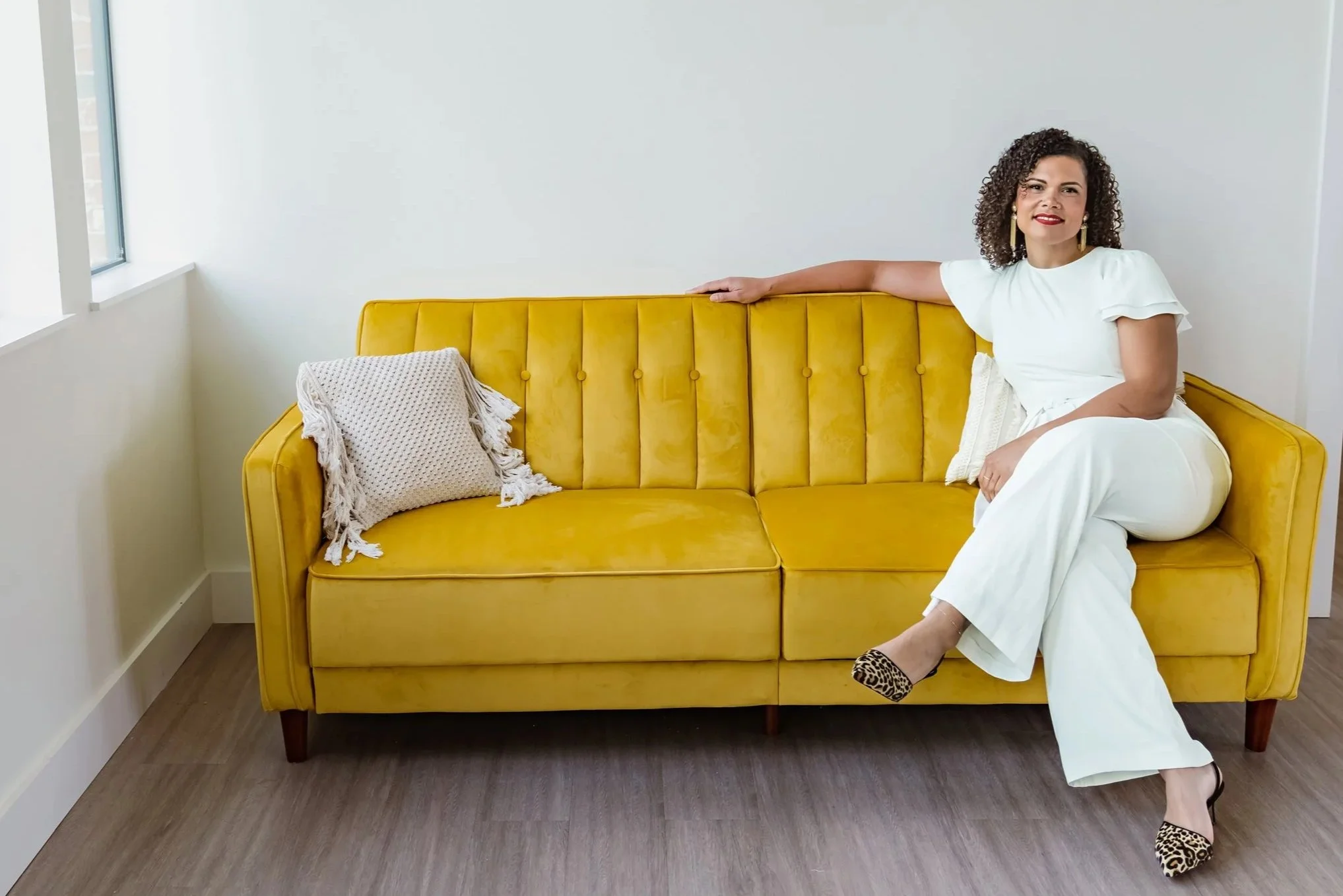 Woman sitting on couch looking out of the window. 