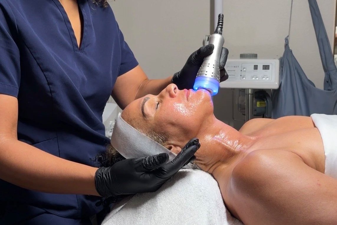 Women Receiving Facial Treatment Using Cold Therapy Wand