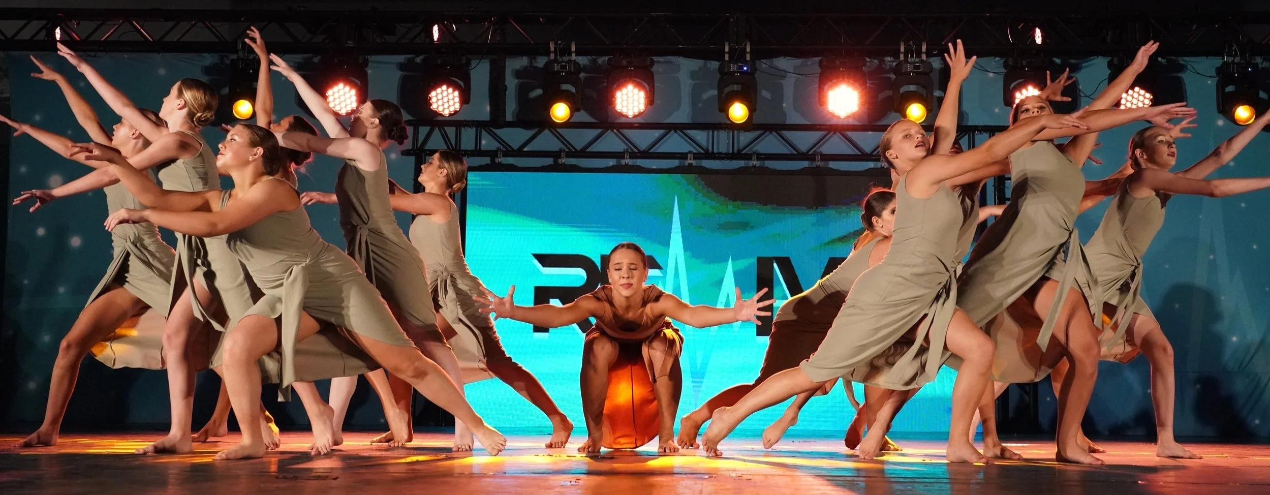 Professional dance competition photography capturing the energy and emotion of a live group performance.