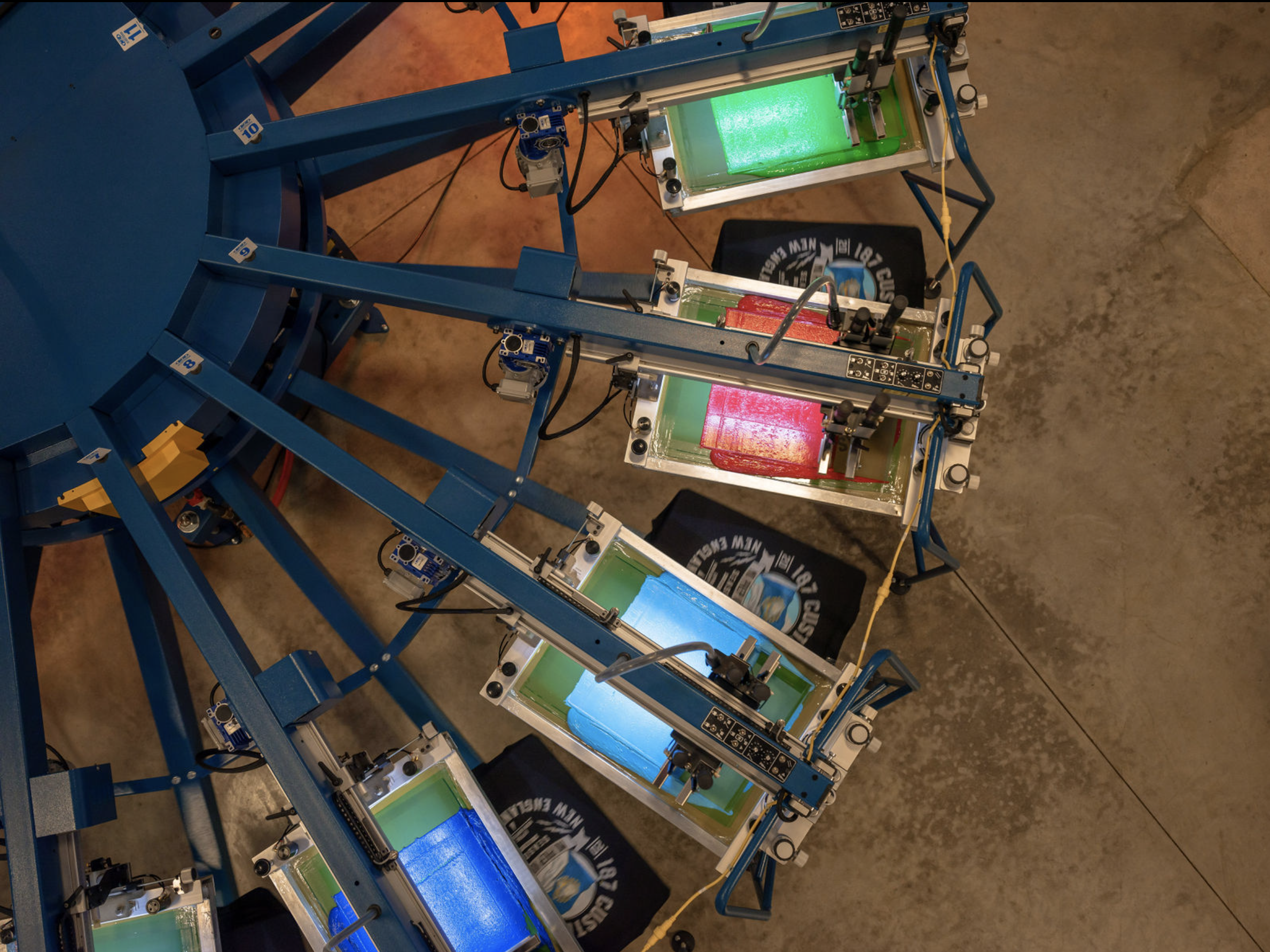 Automated screen-printing press with vibrant inks in production.