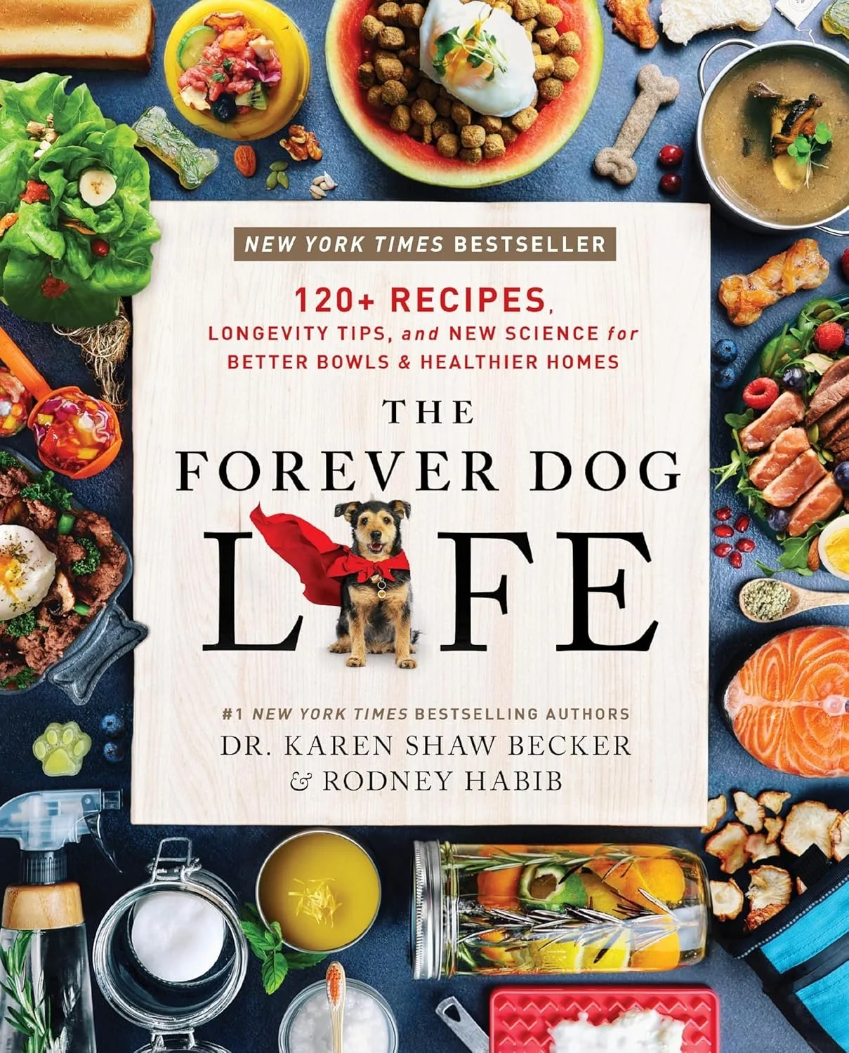 Cover of a cookbook titled "The Forever Dog Life" surrounded by various colorful healthy foods and ingredients, including vegetables, fruits, and bowls of prepared dishes.
