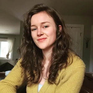 Ivy Ham, clinical herbalist, smiling near a window