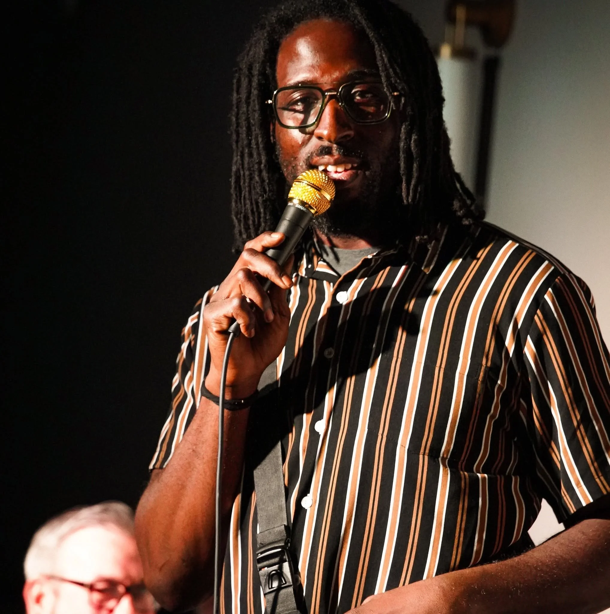 Melo Black performing at helium Comedy club