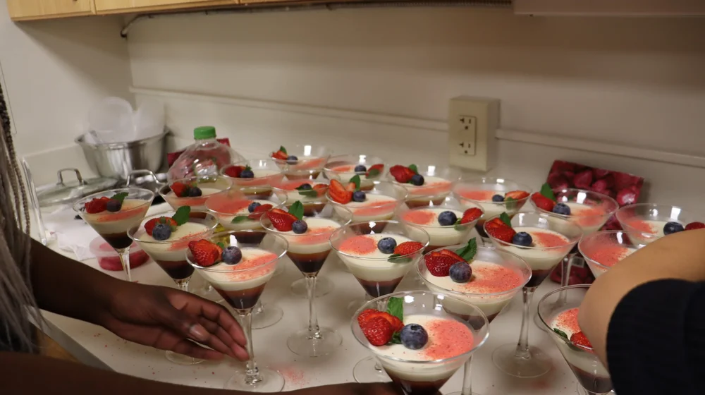 Dessert team finishing the multilayered panna cotta