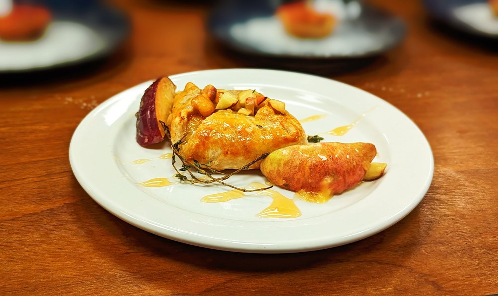 Baked brie with peaches, drizzled in honey