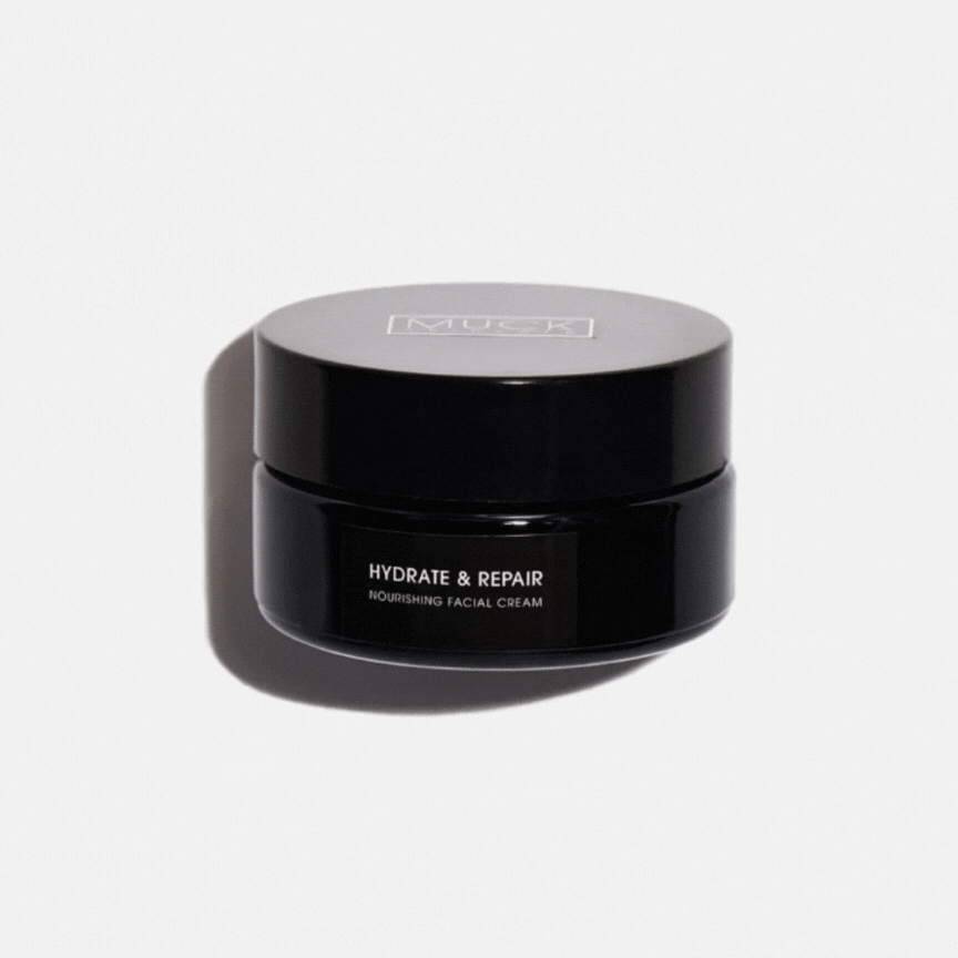 A gif with a black jar of MUCK Hydrate & Repair nourishing facial cream on a white background, closed and then opened.
