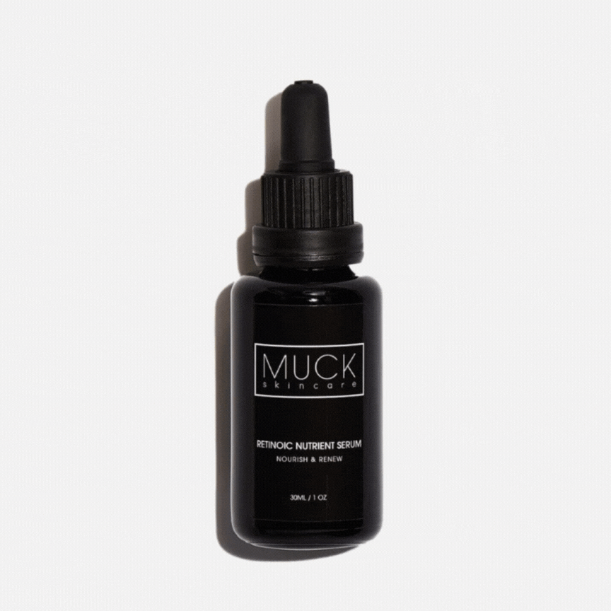 A black bottle of MUCK skincare Retinoic Nutrient Serum with a dropper cap, placed against a plain white background,  closed and then opened.