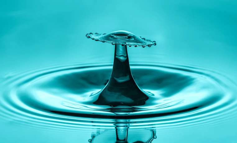 Water droplets forming a pattern on a surface, representing patterns and reflection