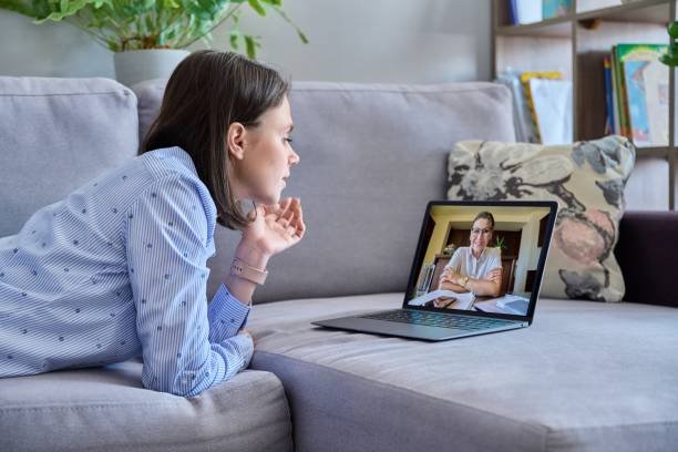 Person participating in online therapy from a comfortable home setting.