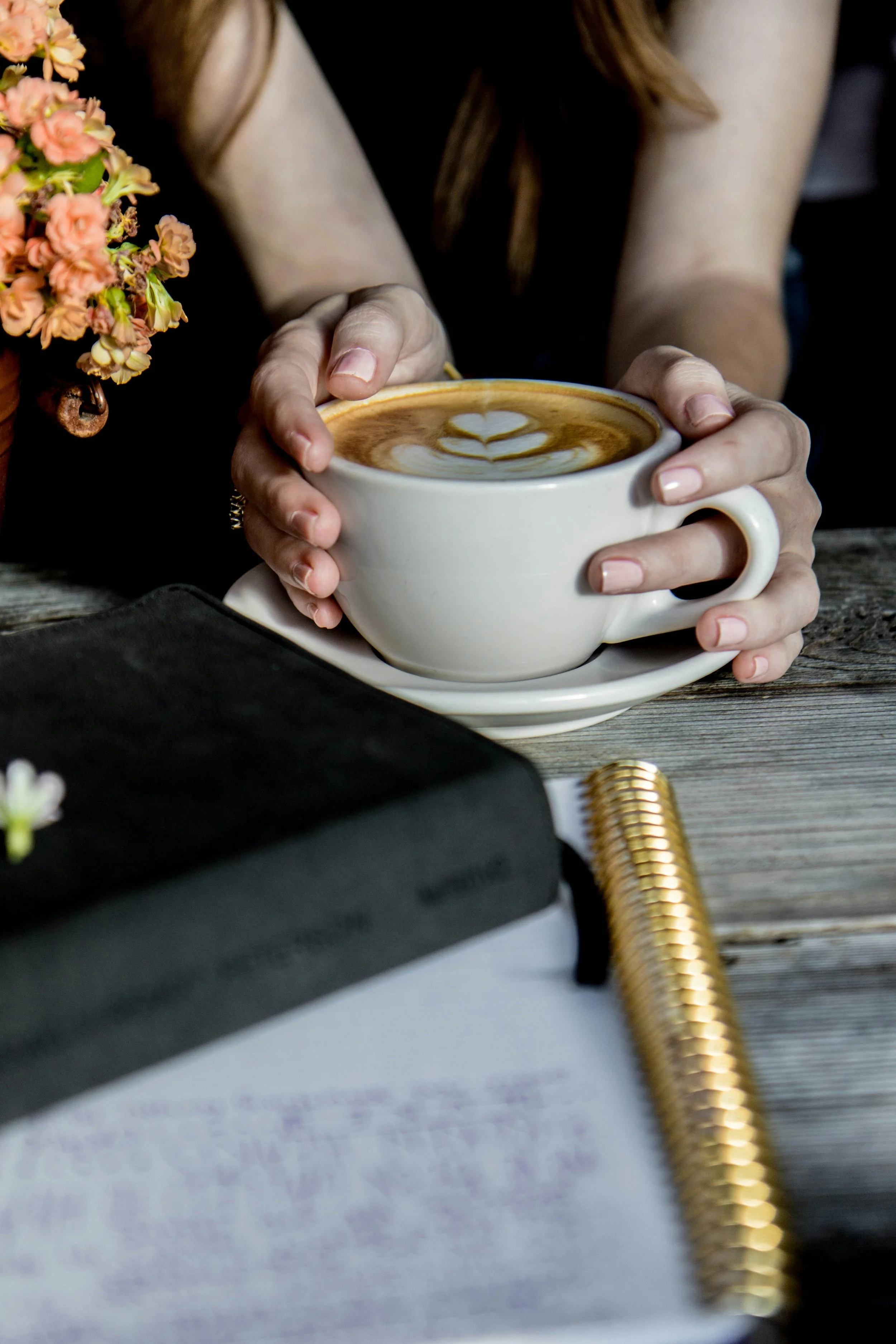 Journal and coffee in soft natural light, representing reflection and self-understanding