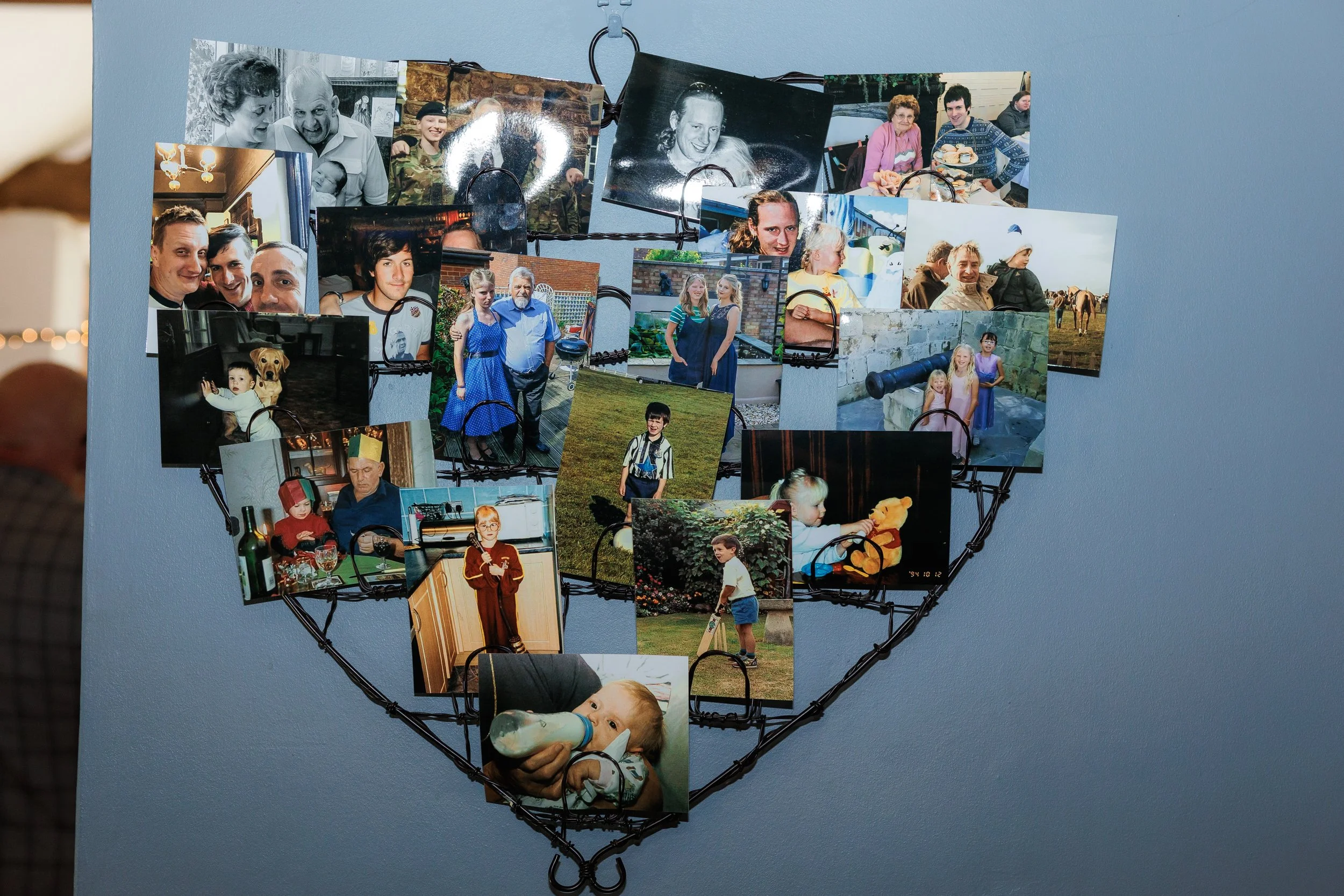 a wire heart photo holder filled with lots of photos of our younger years, and family who couldn't make our day - planning a wedding without a loved one