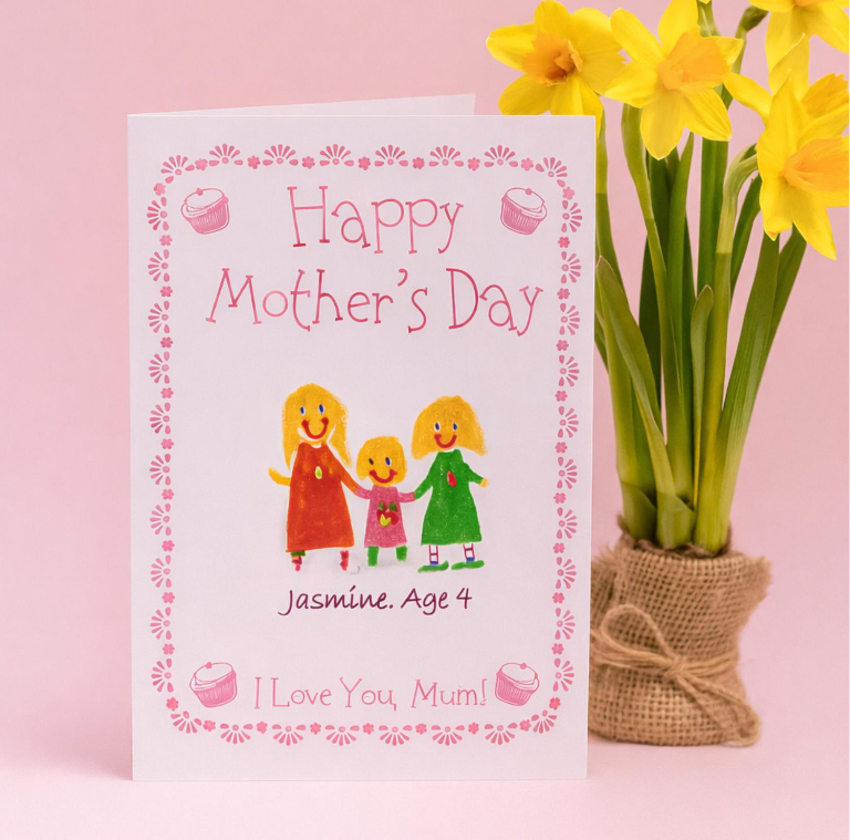 Mother's Day card with a drawing of a mother and two children, pink border with cupcake illustrations, pink background, and a pot of yellow flowers in burlap