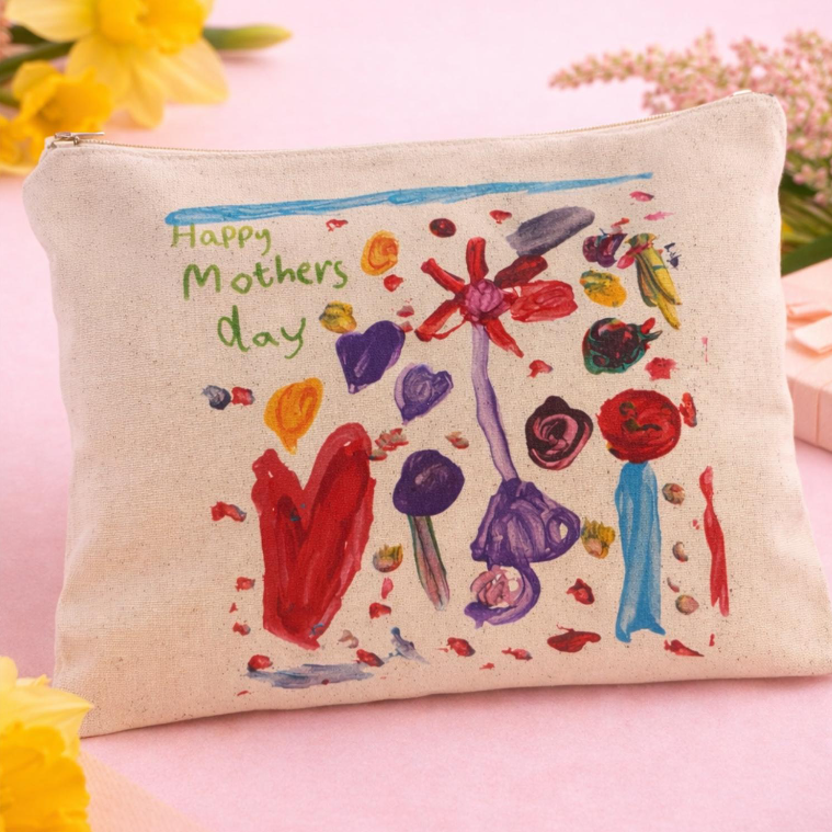 Hand-painted canvas make-up bag with colorful flowers and the text "Happy Mothers Day" on it, surrounded by yellow and pink flowers.