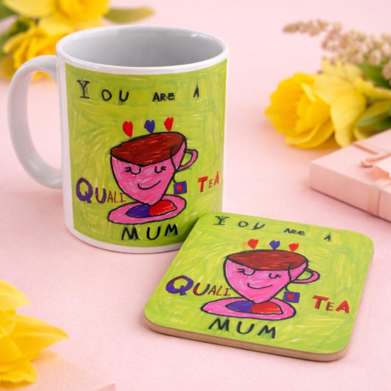 A ceramic mug and a set of coasters with matching colorful illustrations and text. The illustration shows a pink cup with a smiling face, surrounded by hearts, on a yellow-green background.