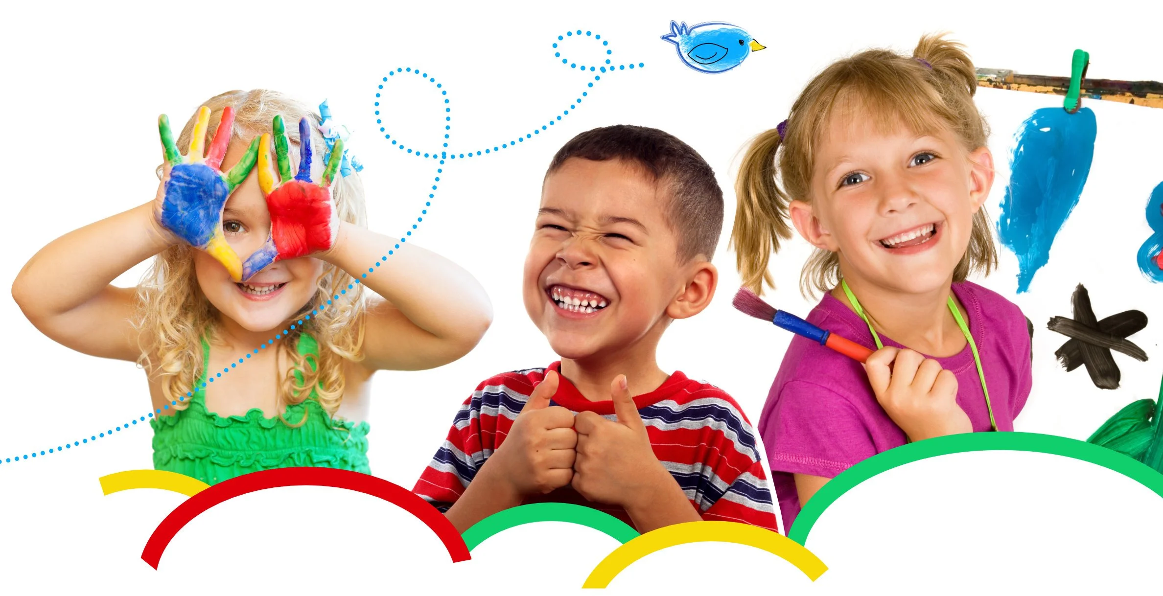 Three children smiling and having fun in a colorful setting with painting supplies and painted hands.