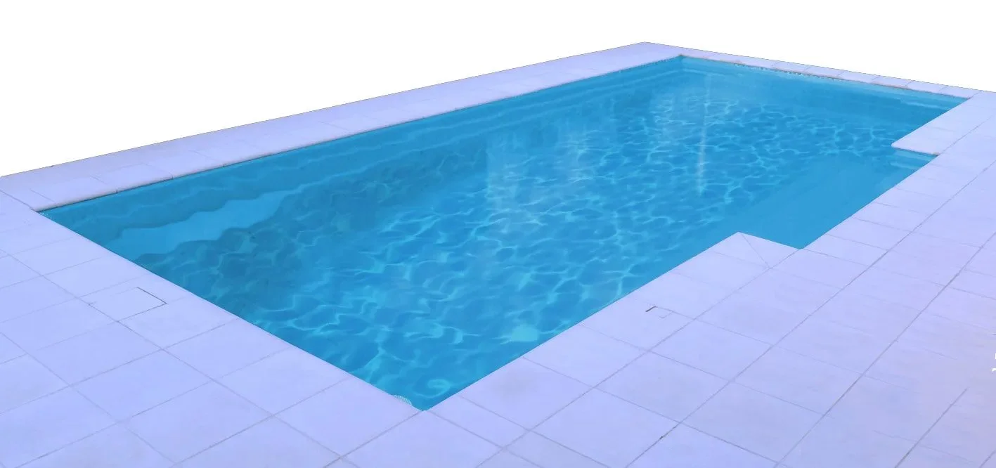 A rectangular swimming pool with blue water, surrounded by white tiled decking.