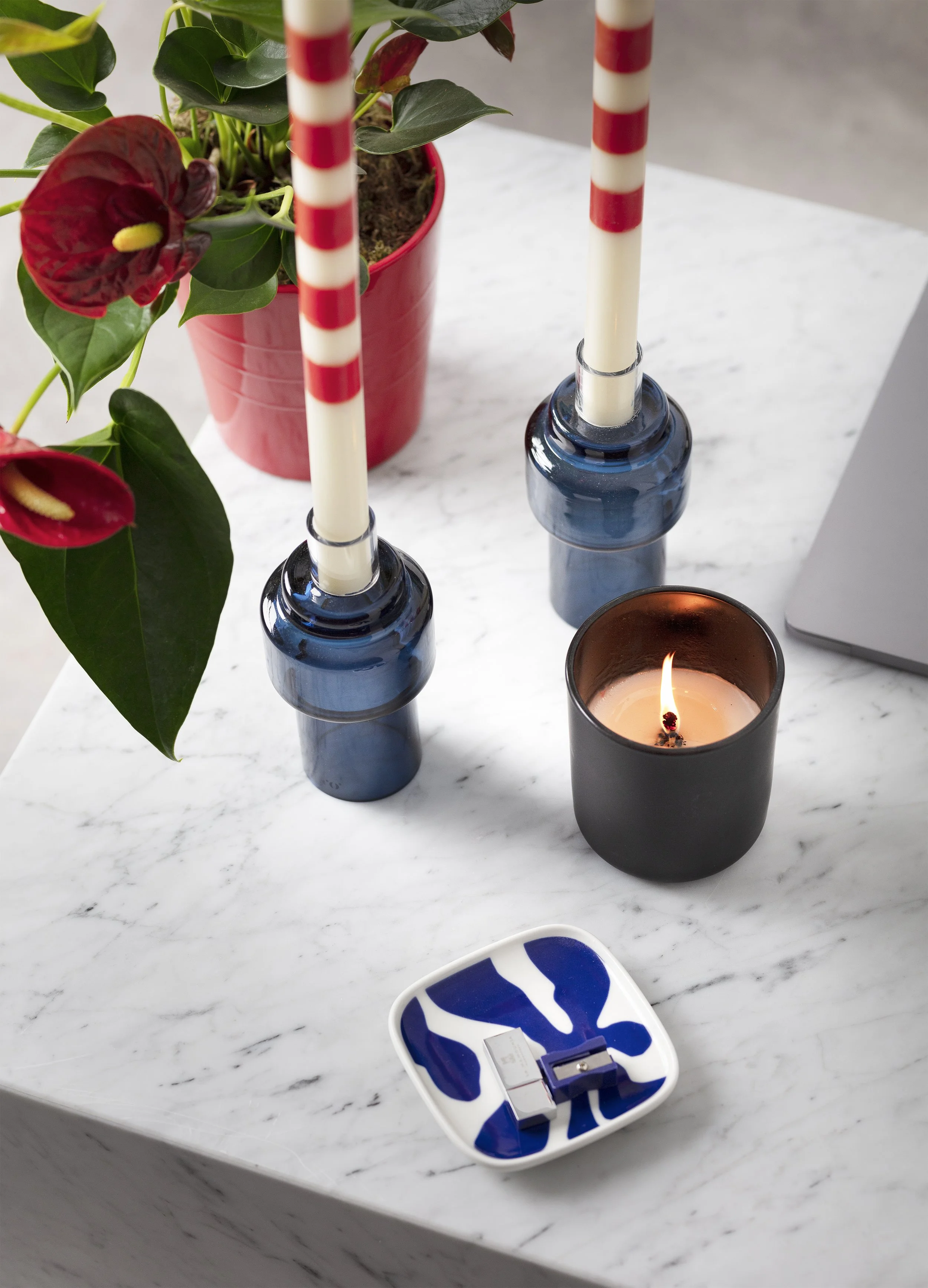 Prop shot featuring blue candles and a laptop, for Designs For Growth