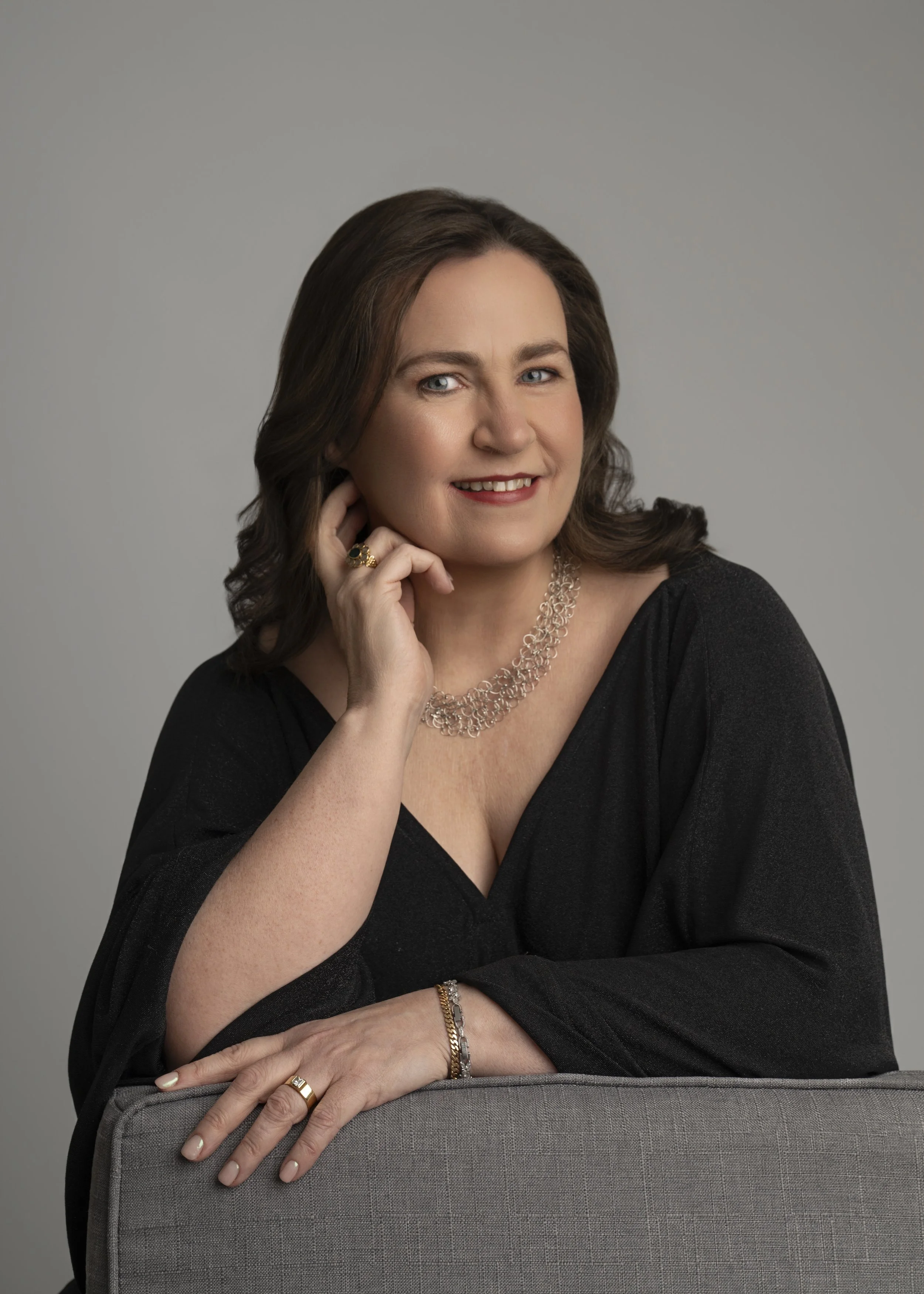 Lucy O'Reilly of Designs For Growth, wearing a black long-sleeve blouse, smiling at the camera.