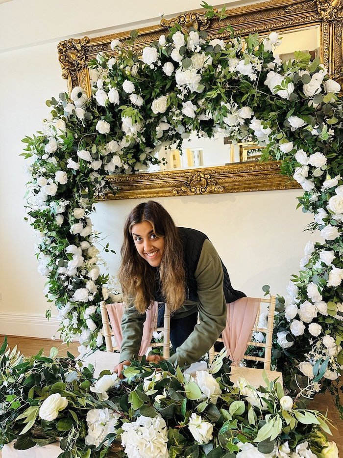 Hunaida setting up the table placements on the top table