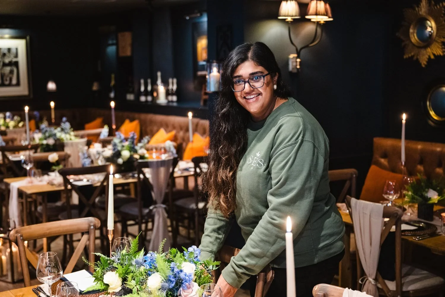 Amara setting up wedding tables styling.