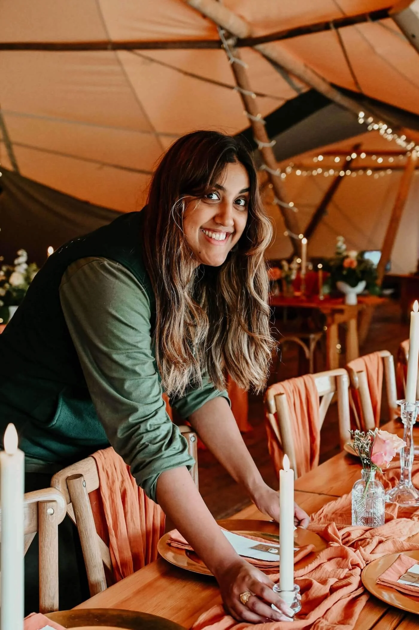 Hunaida setting up the table placements on the top table