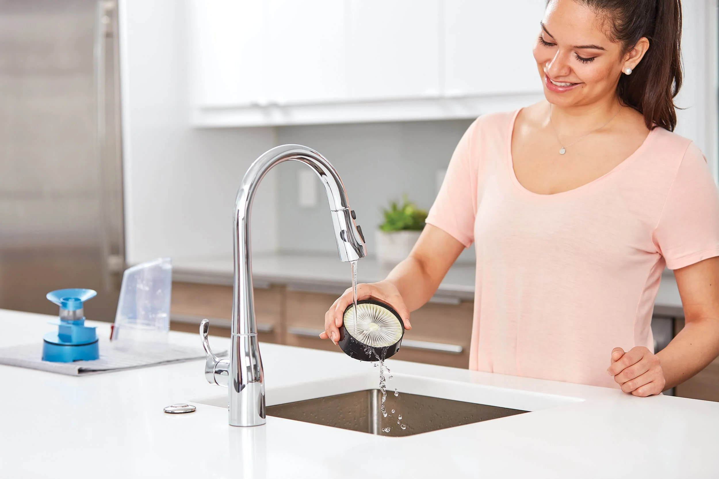 woman-sink-cleaning-vacuum-filter.jpg