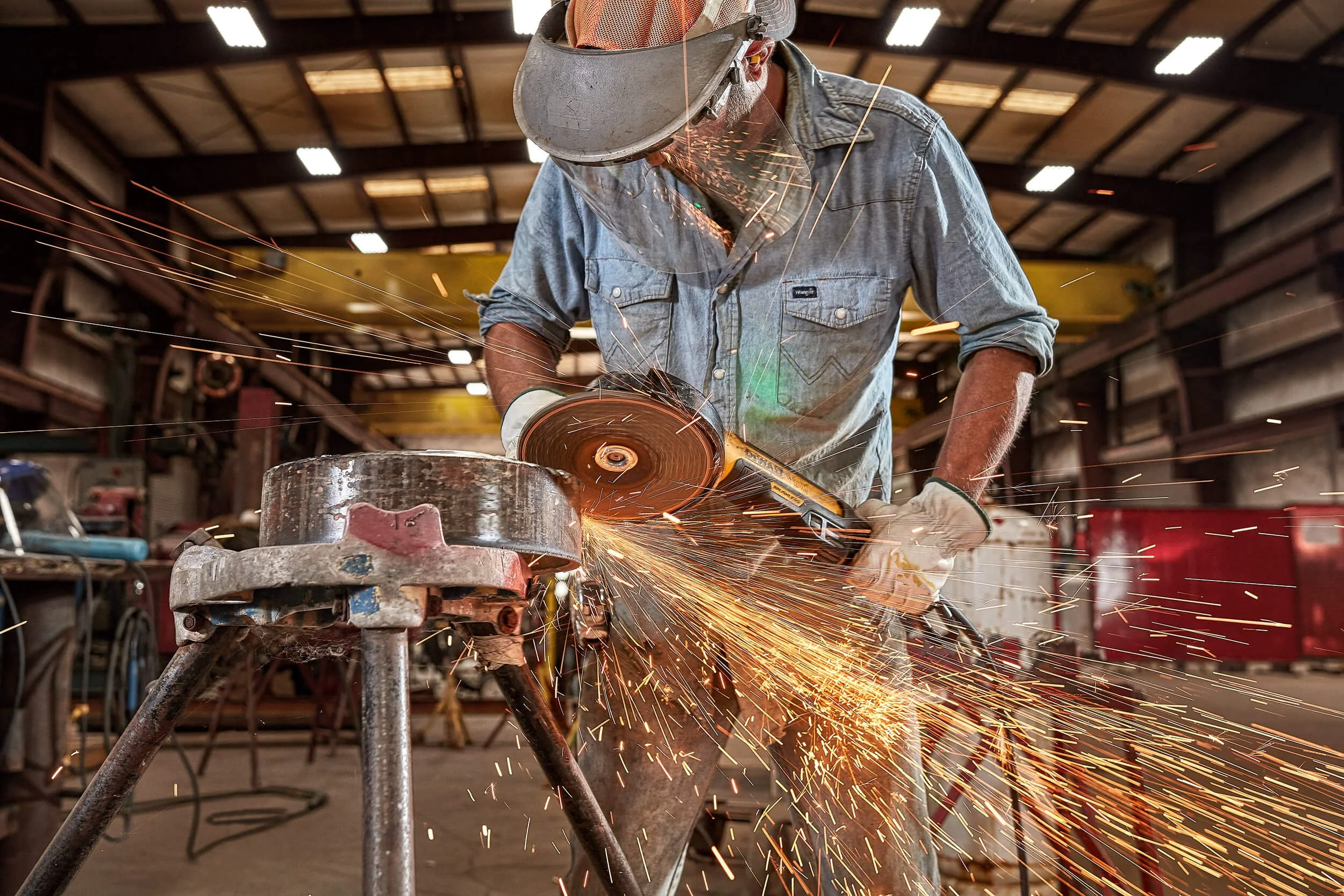 grinder-grinding-pipe-sparks-in-fabrication-shop-01.jpg