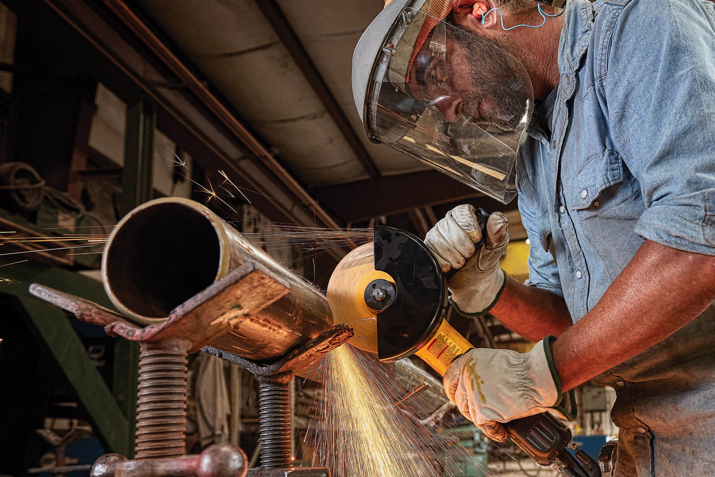 grinder-grinding-pipe-sparks-in-fabrication-shop-02.jpg