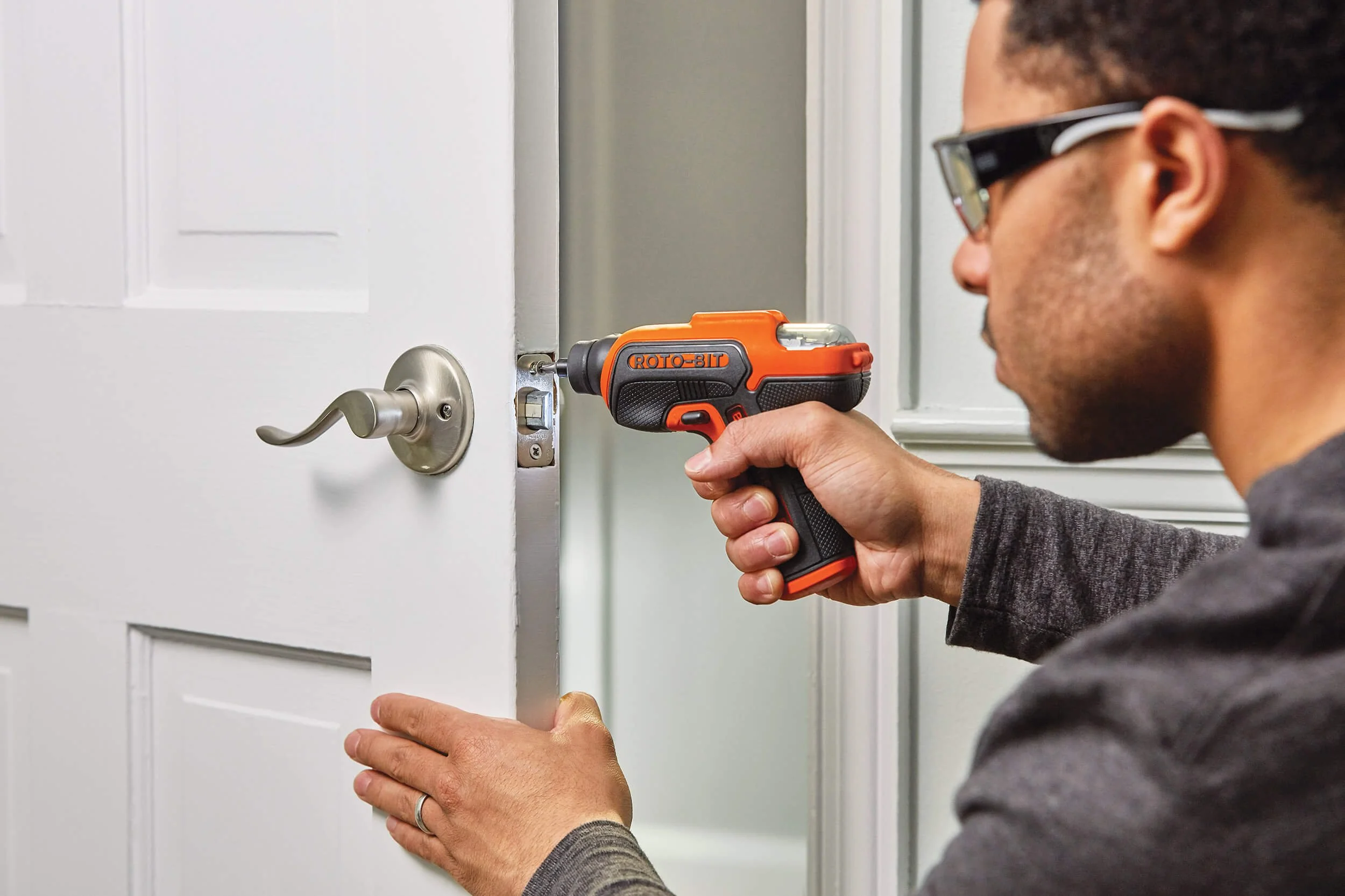 man-doorway-powered-screwdriver-in-use-doorway.jpg