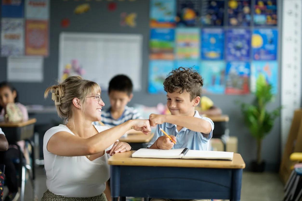 An adult and child working together on a learning activity.