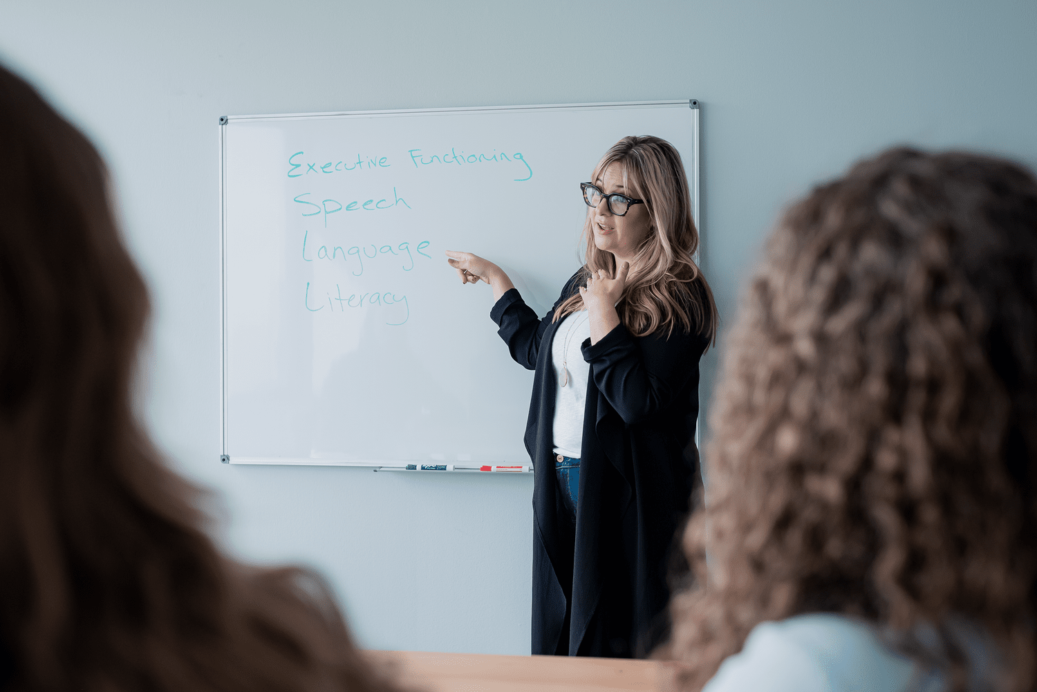 Tera teaching executive function concepts at a whiteboard