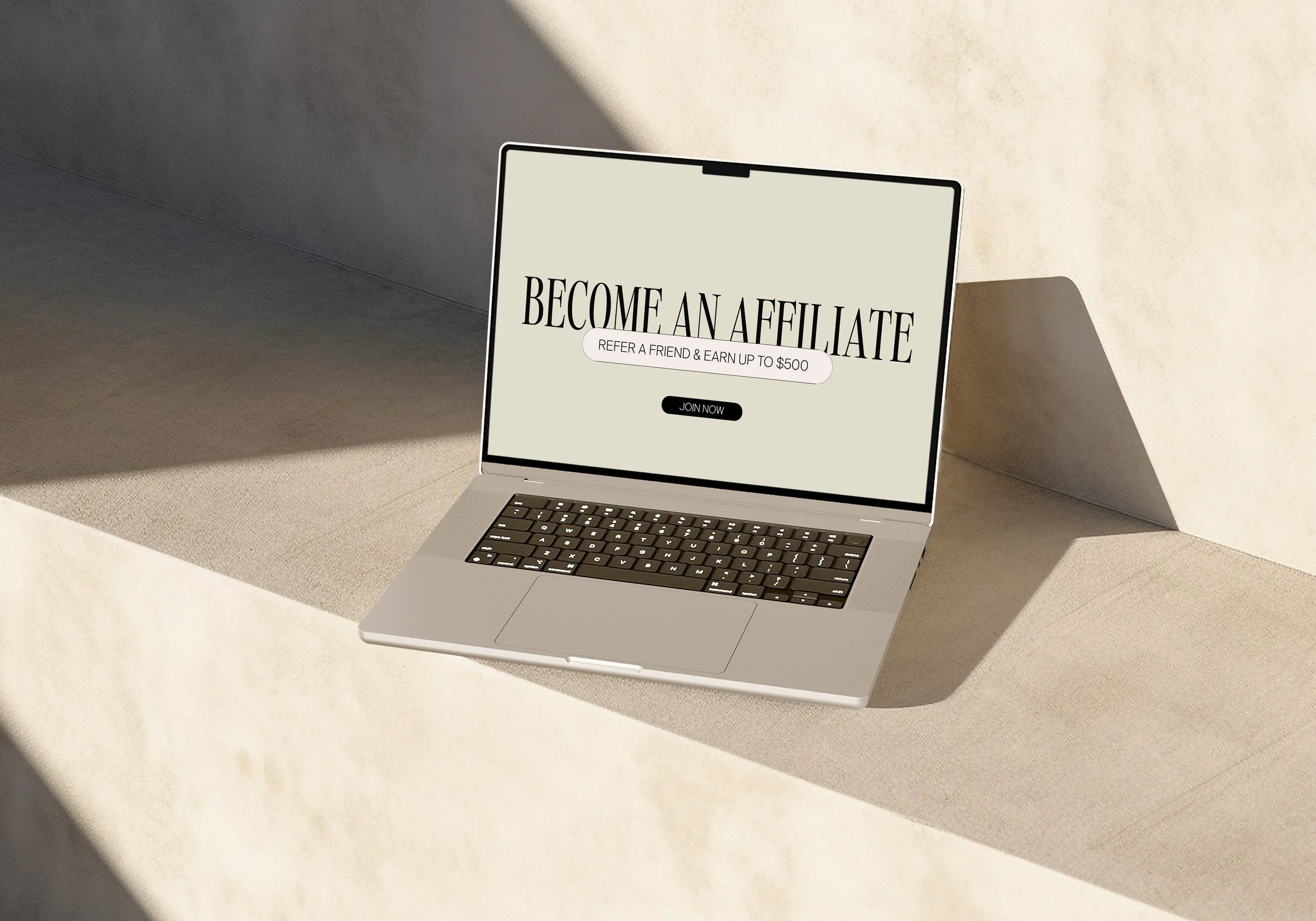 Open laptop on a beige surface with a message on the screen that says "Become an Affiliate" and a button labeled "Join Now."