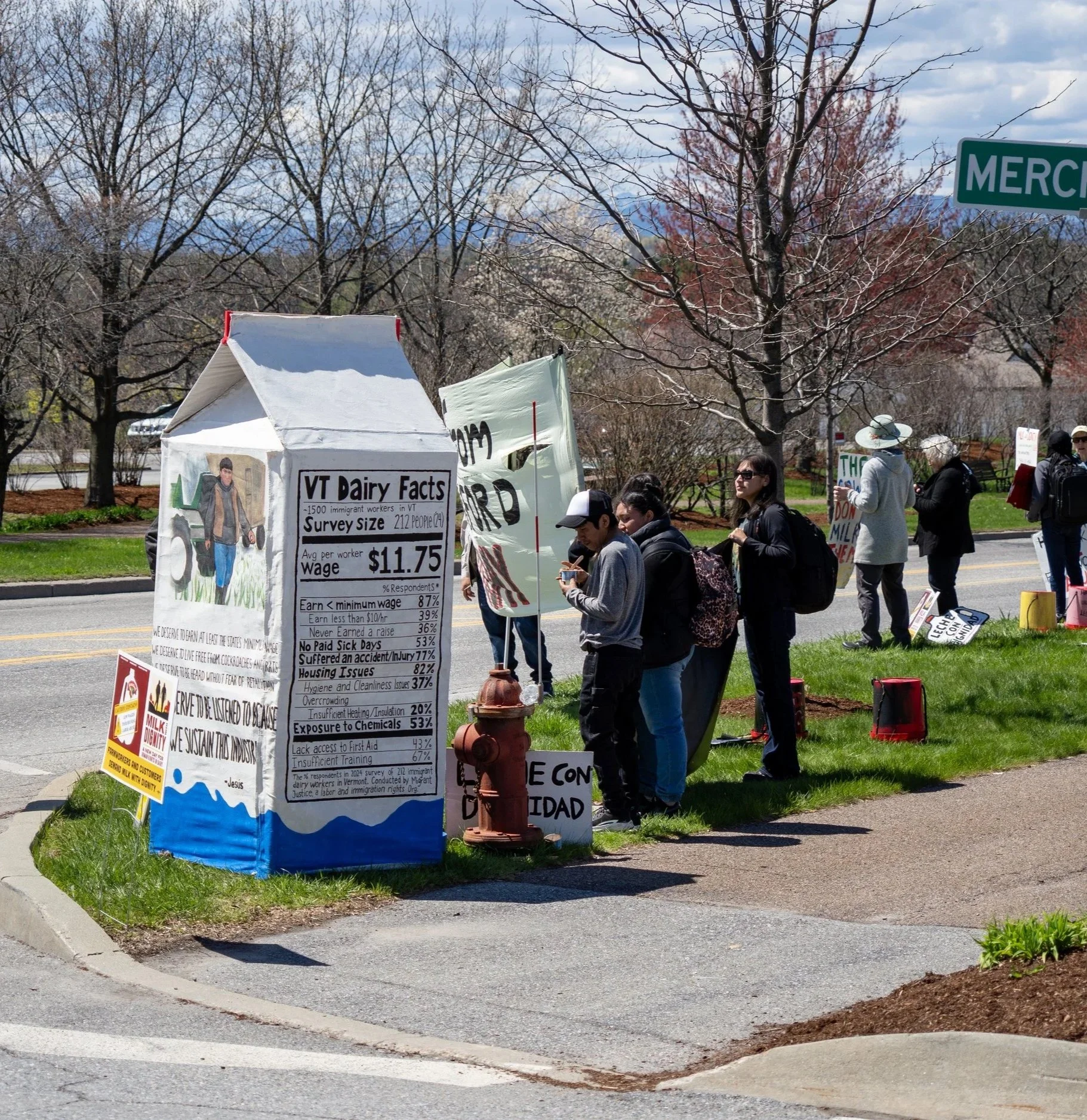  A giant milk carton at the picket lists human rights abuses in the form of a nutrition panel: 87% of workers make less than minimum wage; 77% have suffered an accident or injury on the job; 82% report issues with unsanitary, underheated, or overcrow