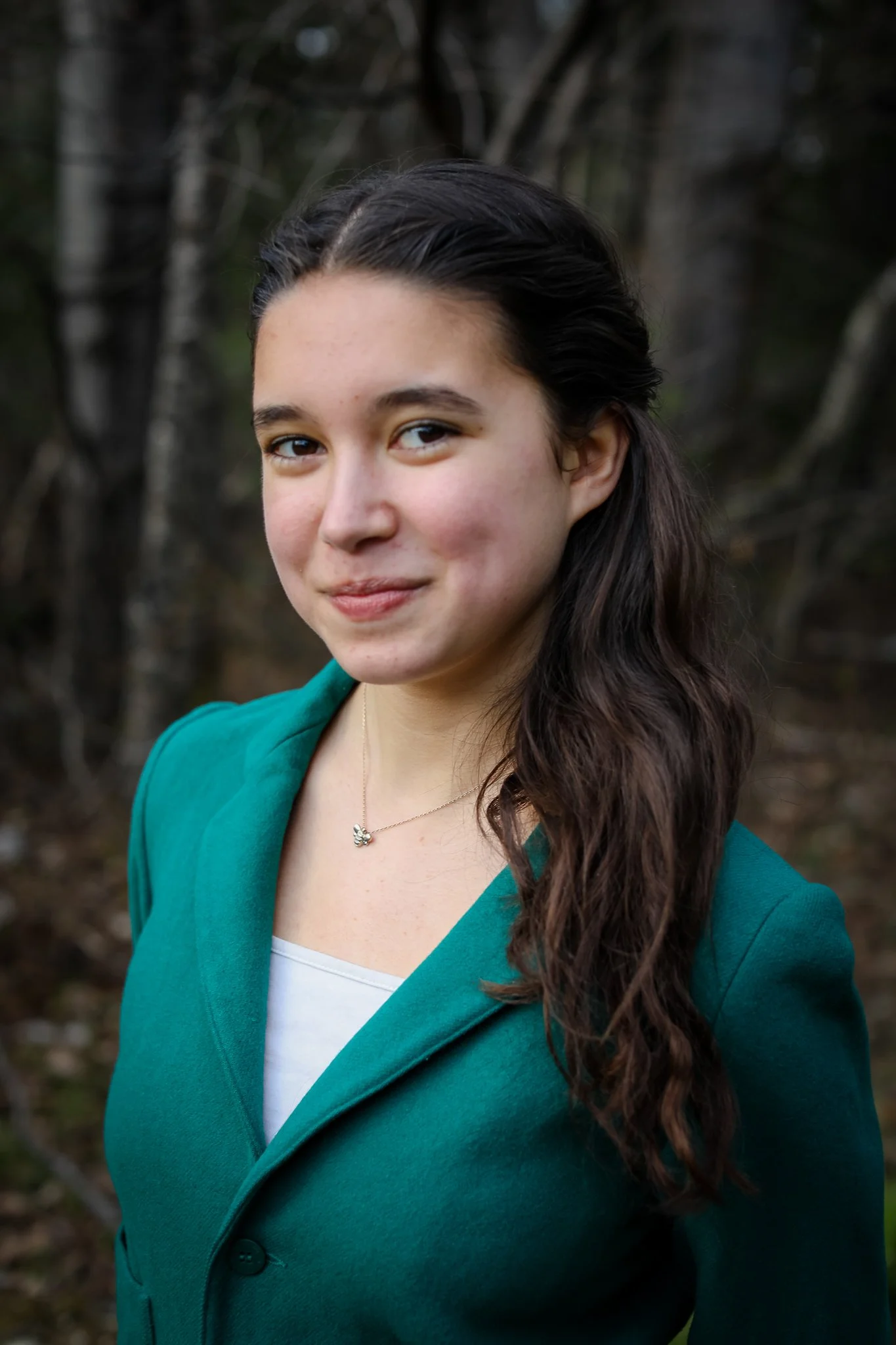 Headshot of Harmony Bell Devoe, Organizing Intern, in teal suit