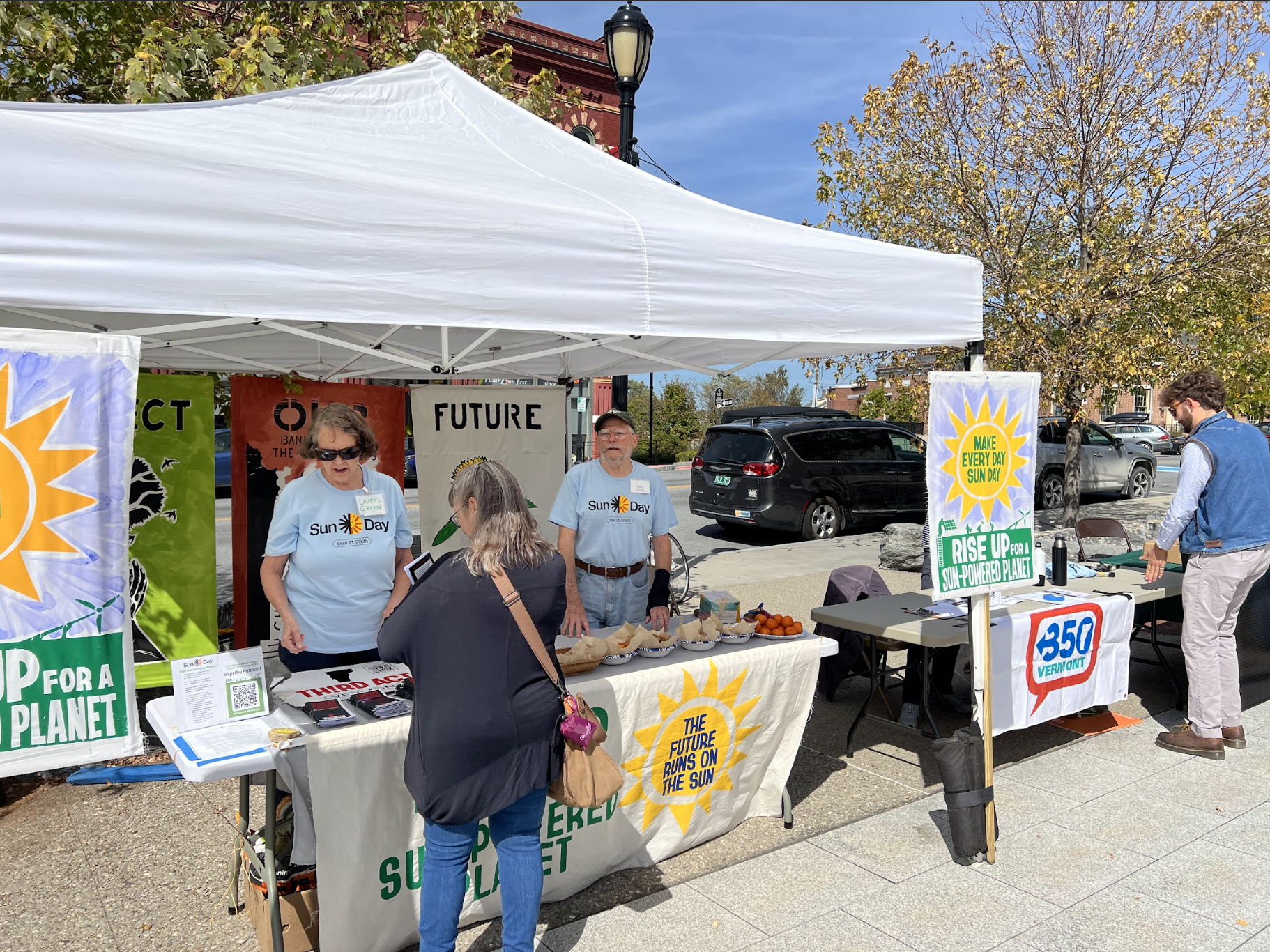 Addison node volunteers tabling under a tent at Sun Day