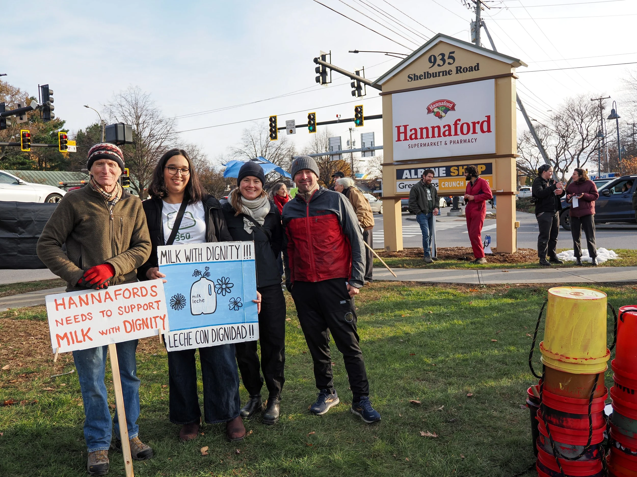 Volunteers and Staff smiling with signs at a Milk with Dignity protest