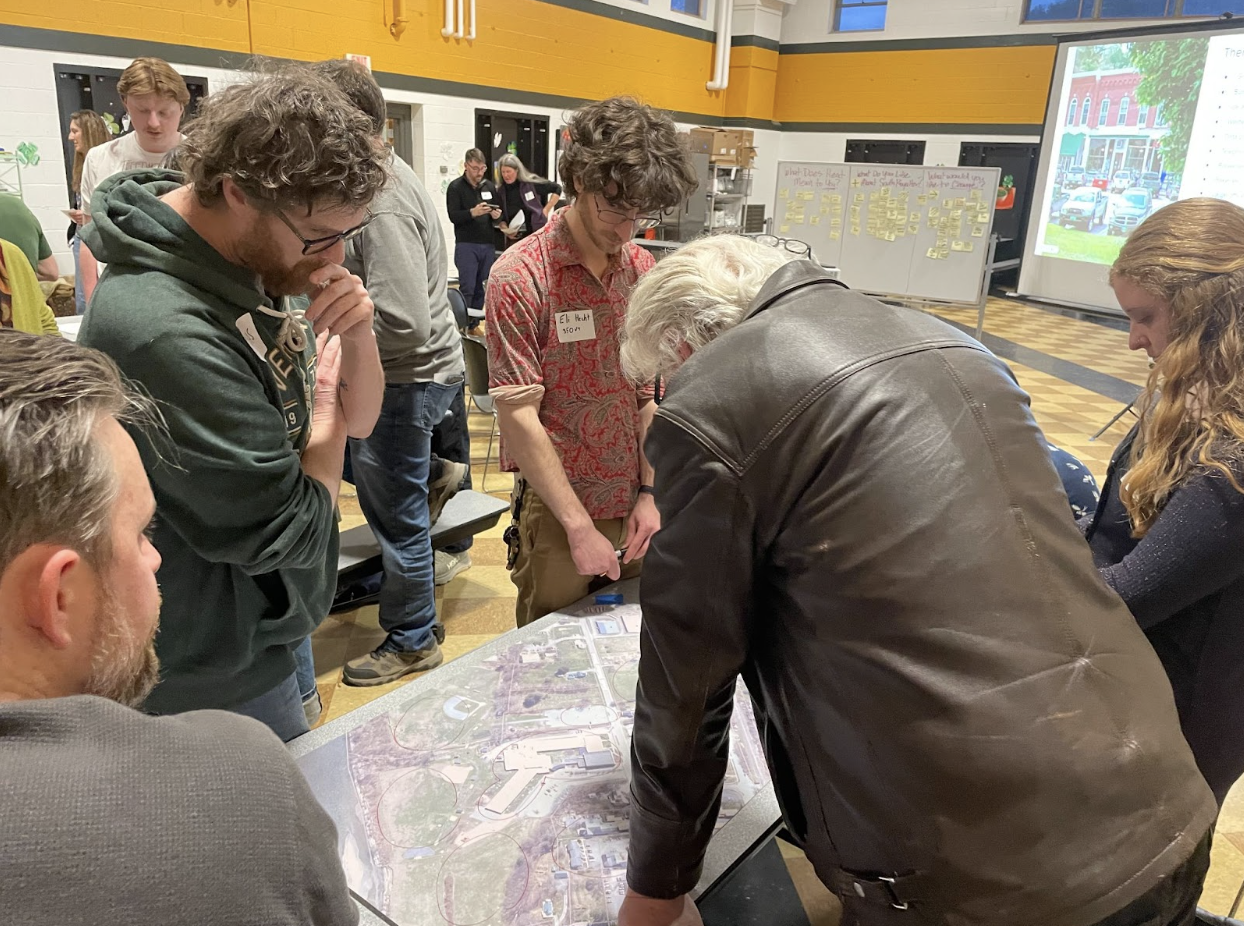 Volunteers leaning over a table reading map