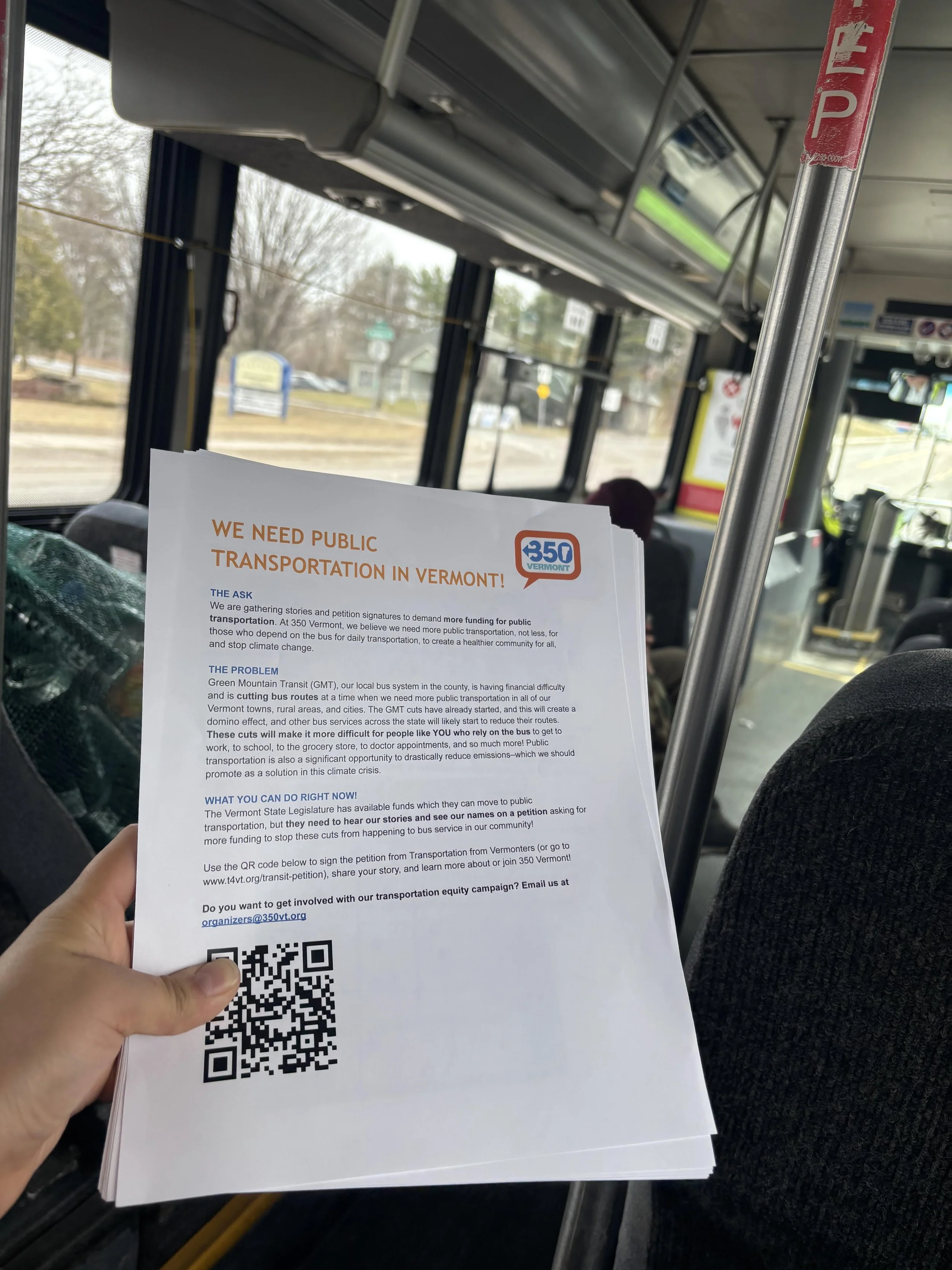Handouts that read "We Need Public Transportation" being distibuted on a bus