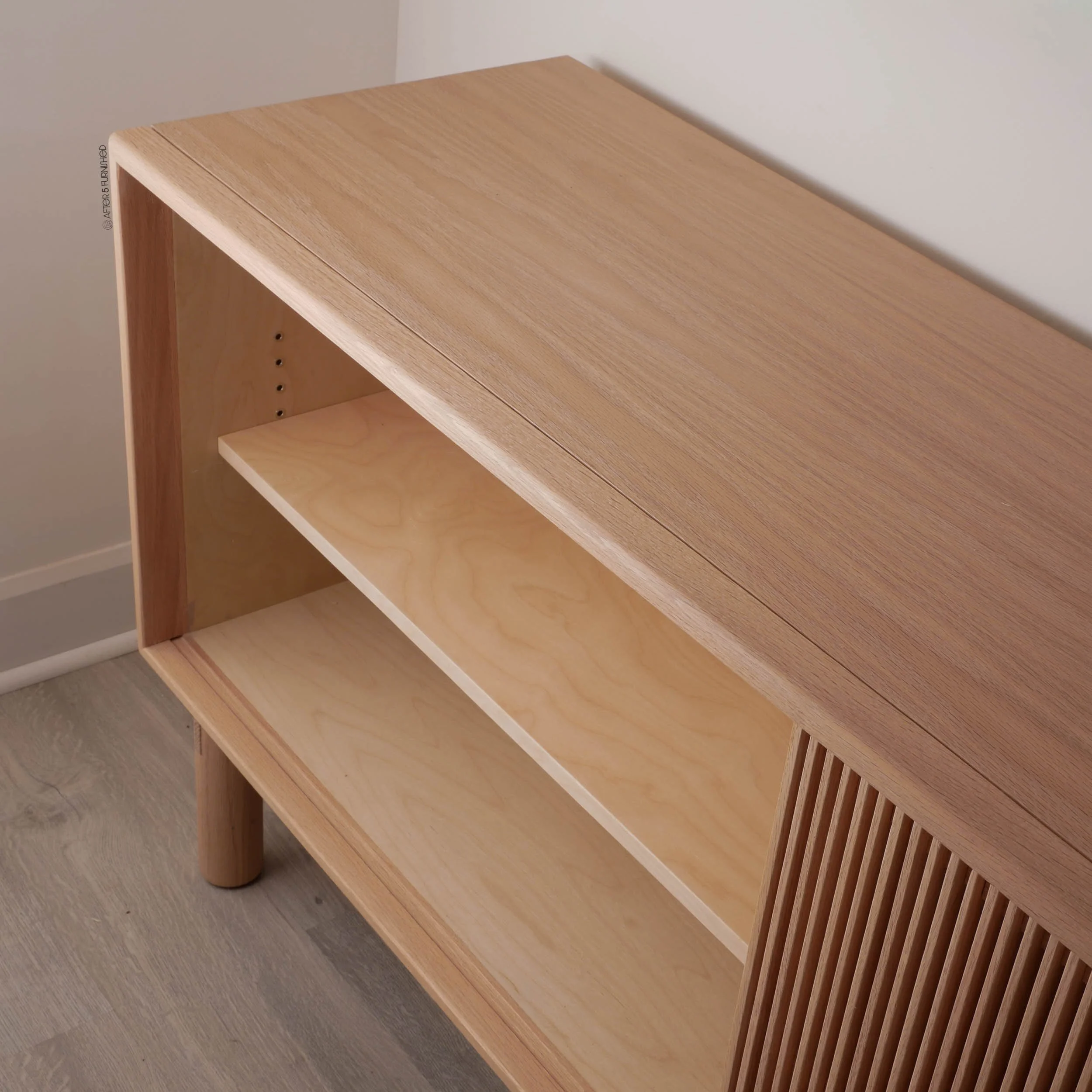 Custom handcrafted oak media console with sliding slatted front, minimalist Scandinavian design furniture made in Toronto