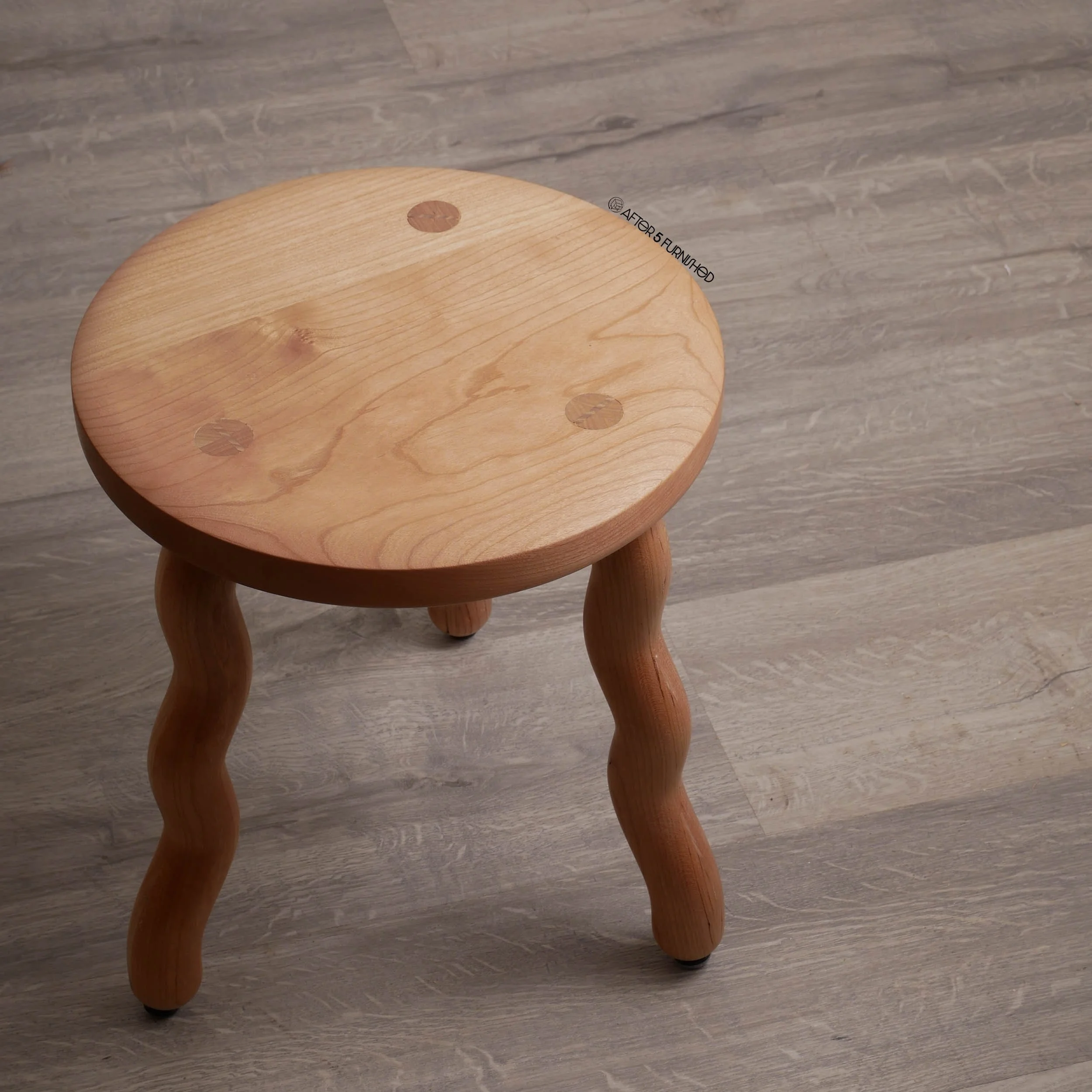 Decorative wooden stool with playful curved legs