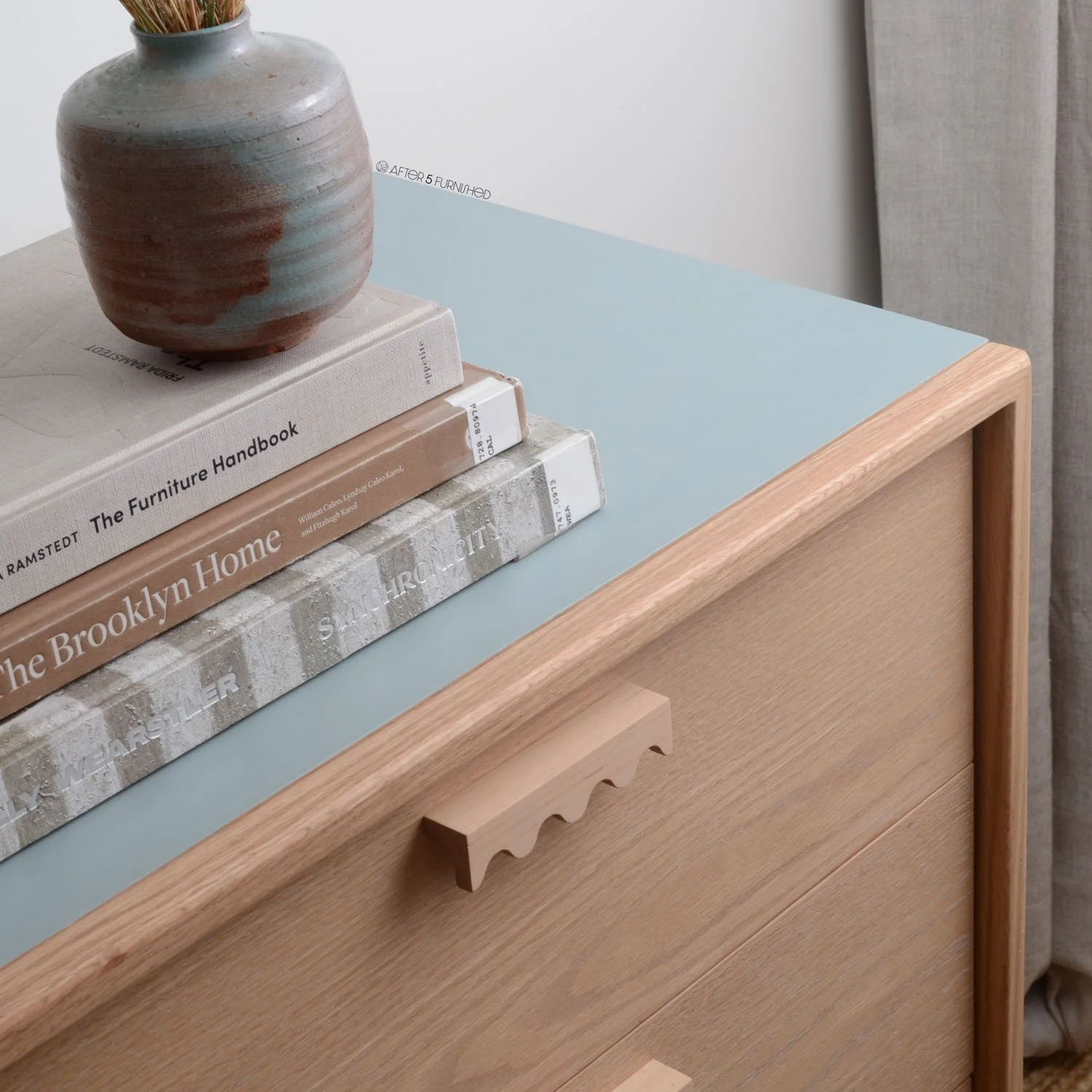 Front view of modern nursery dresser with squiggly maple drawer pulls