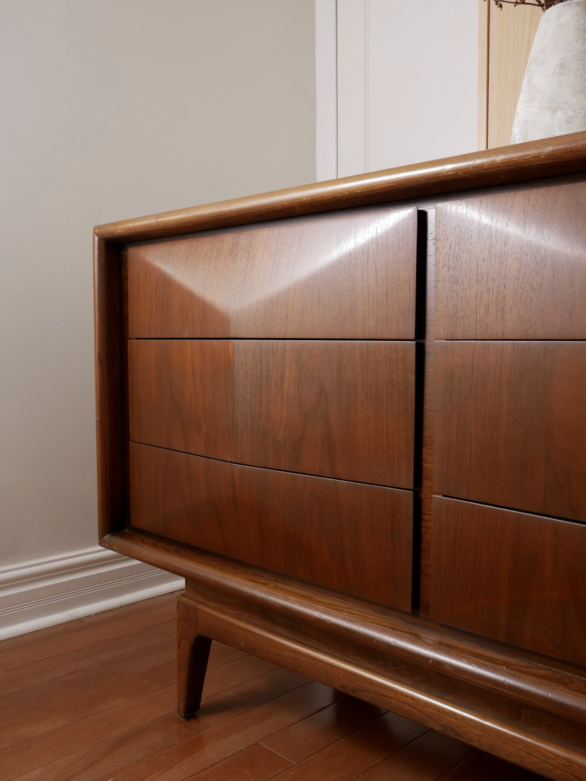 Refinished mid century walnut dresser with geometric carved drawer fronts and ample storage