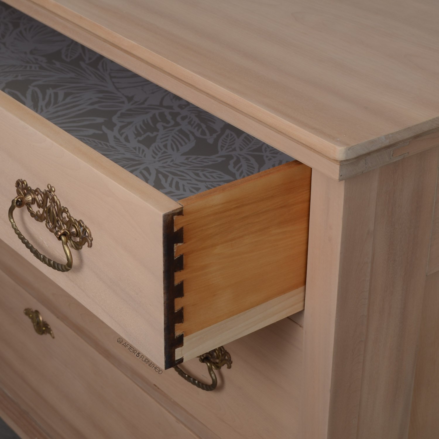 Detail of dovetail joinery and craftsmanship on vintage maple dresser