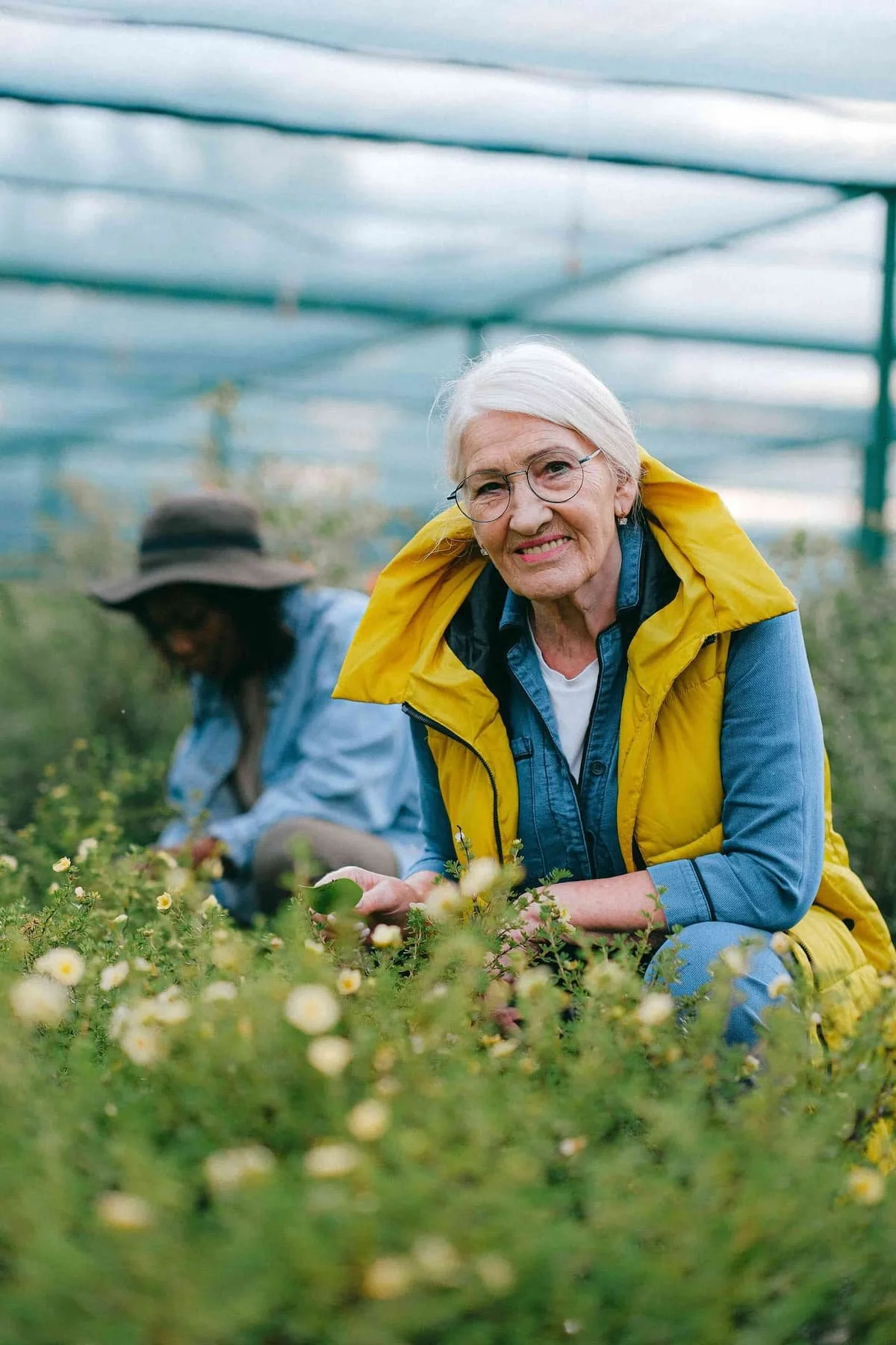 retired woman in greenhouse