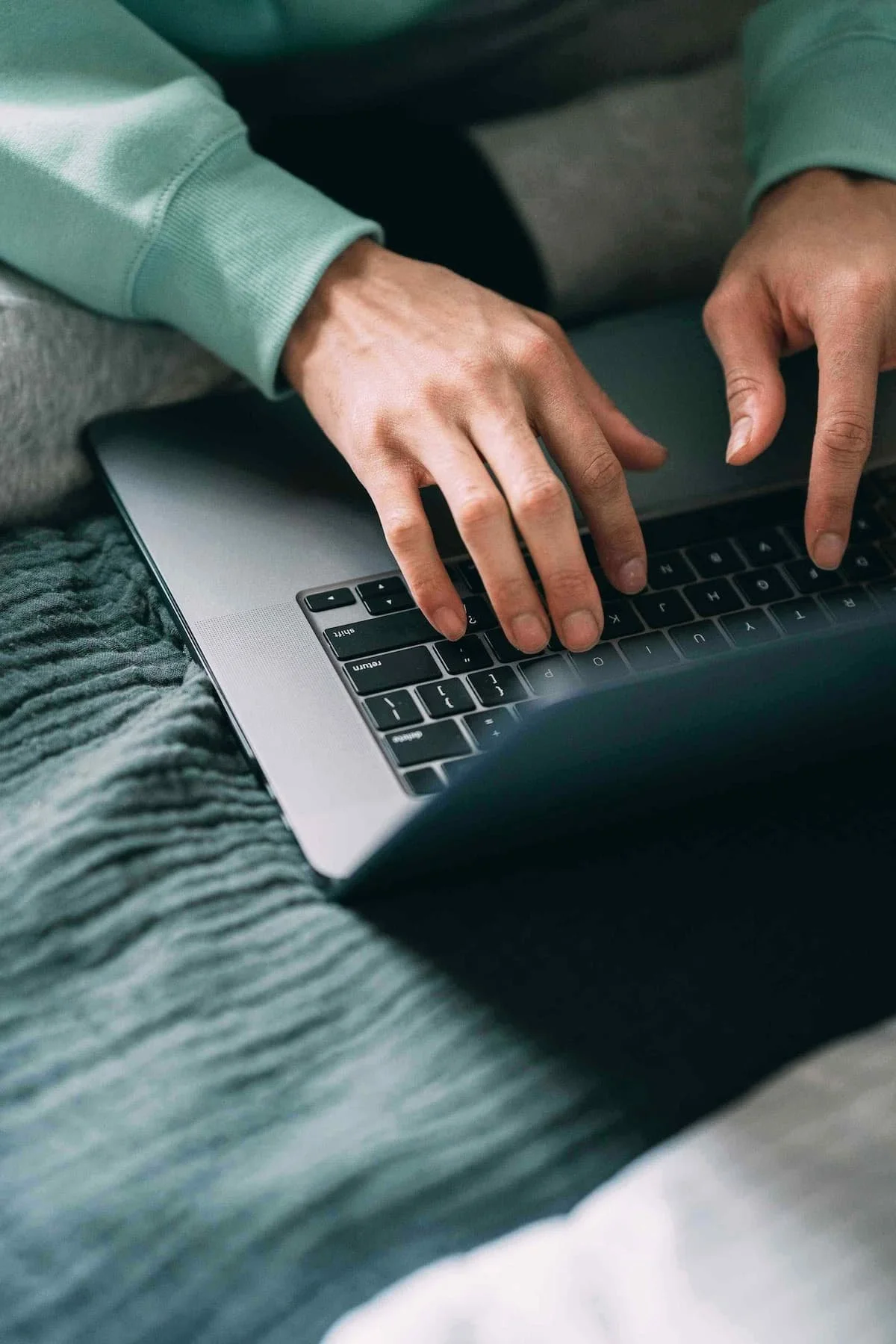 man hands typing on laptop
