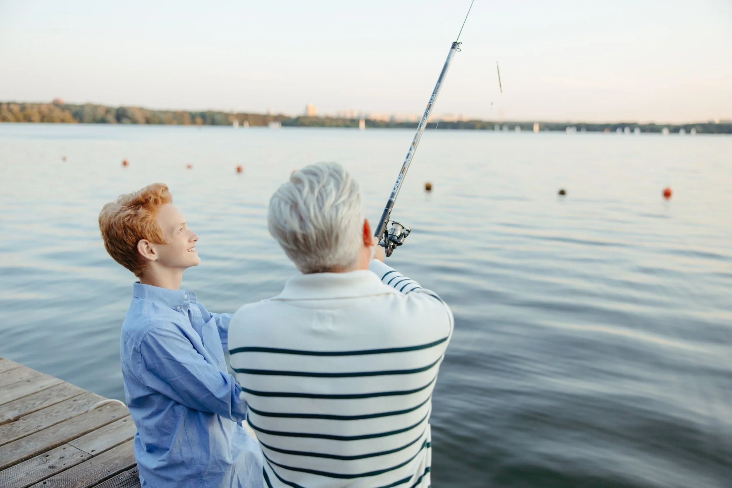 teen and dad fishing off a dock