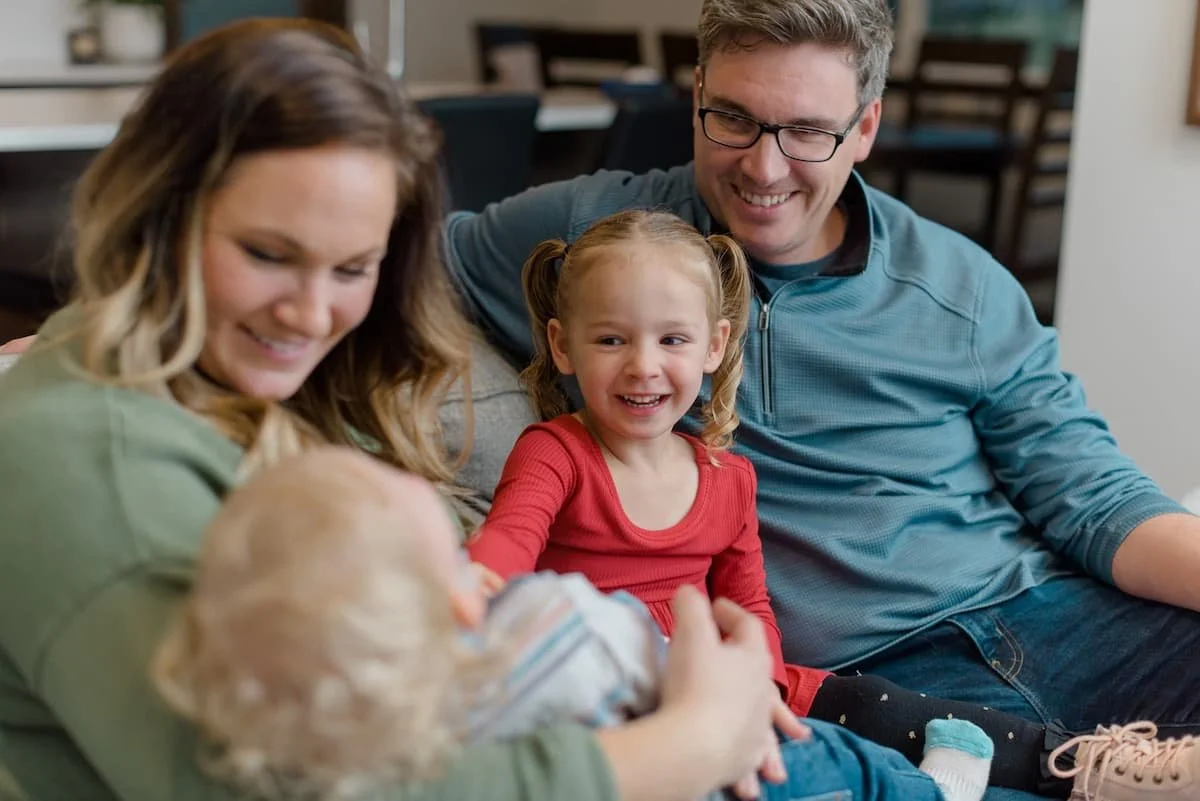 family hanging out on couch in living room
