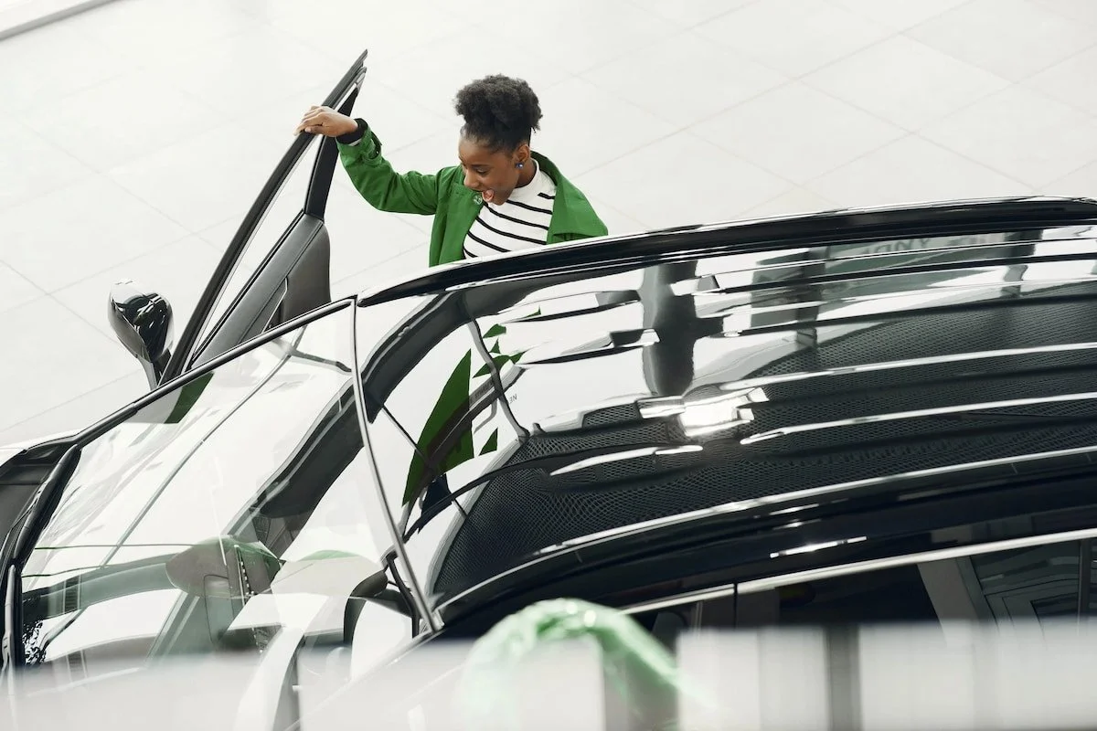 Image of a woman opening a car door.