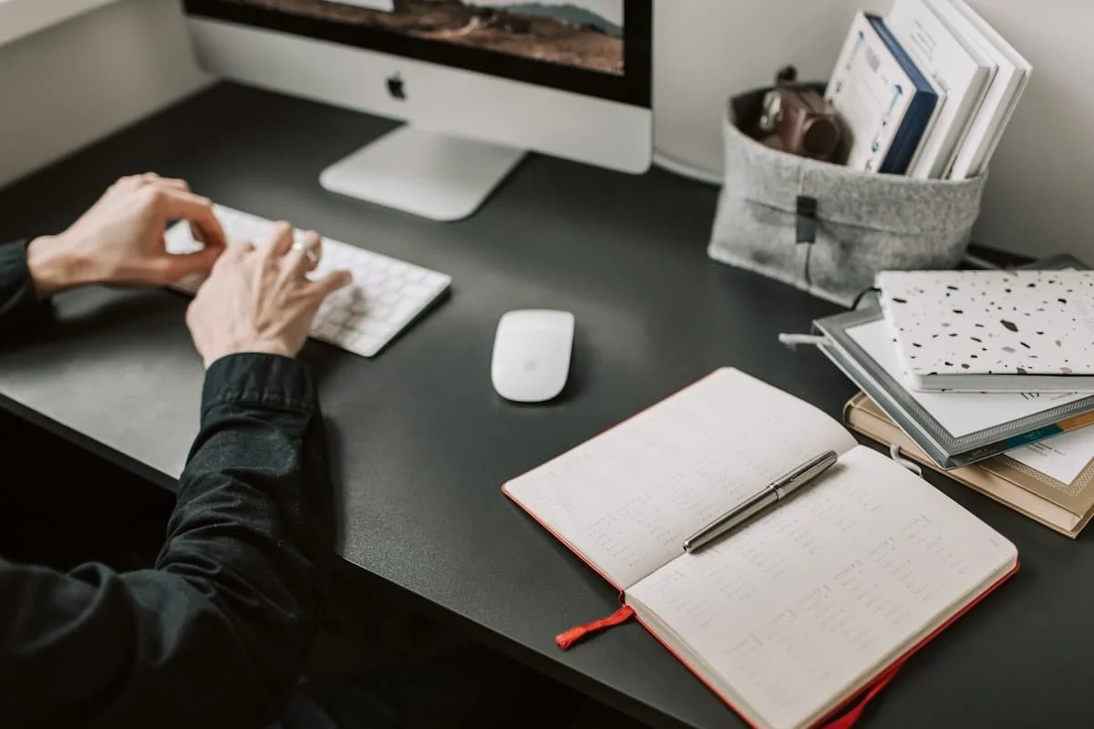 man working on computer at in home desk